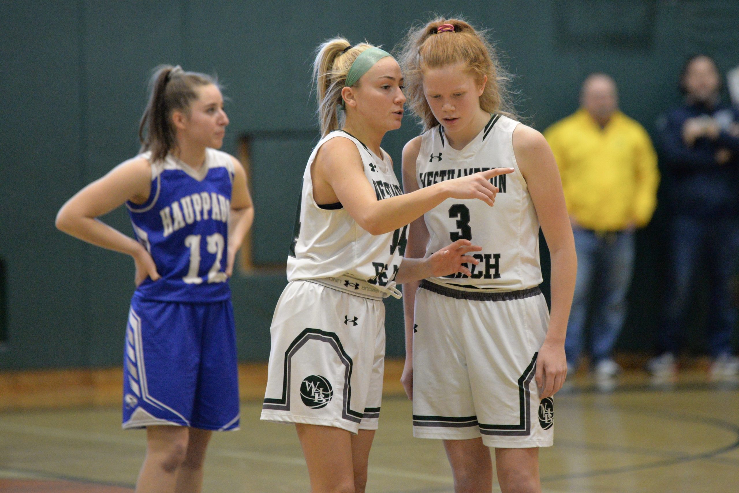 Westhampton Beach senior Isabelle Smith shares a few pointers with sophomore Molly McCarthy.