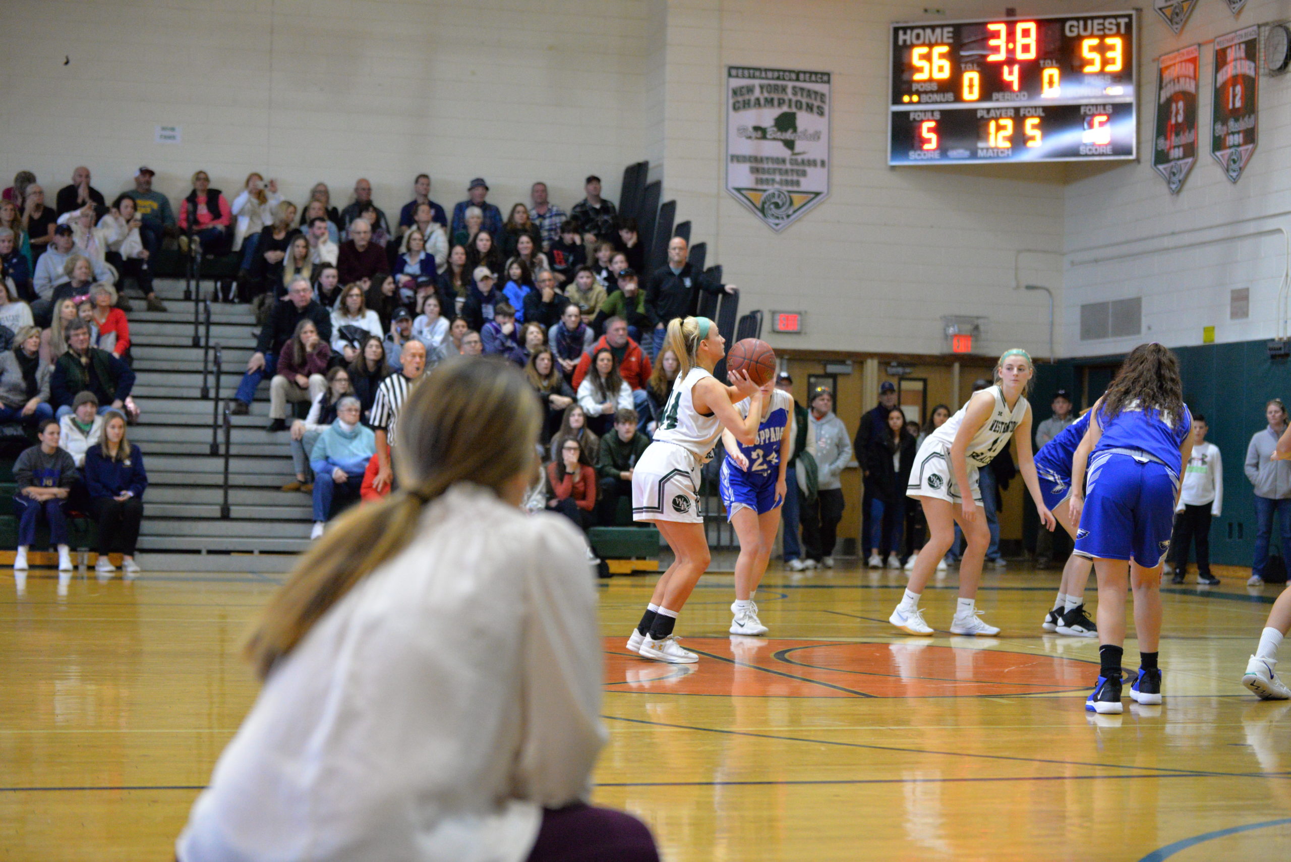 Westhampton Beach head coach Katie Peters watches on as her senior Isabelle Smith puts the finishing touches on a county semifinal win.