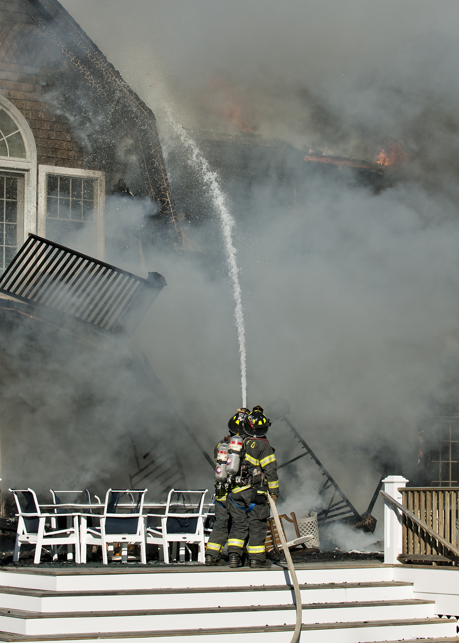 Firefighters atttacking the flames at a home on Michaels Way in Westhampton Beach yesterday afternoon.