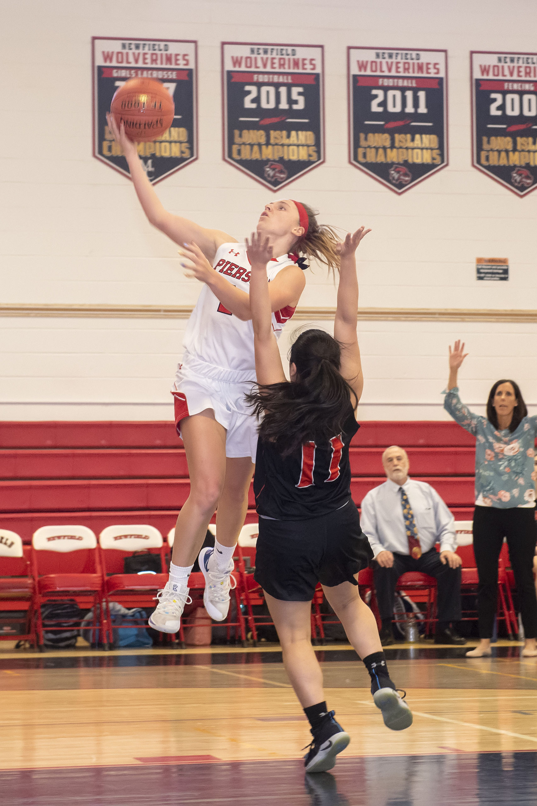 Pierson junior Grace Perello takes on an East Rockaway player as she heads toward the basket.