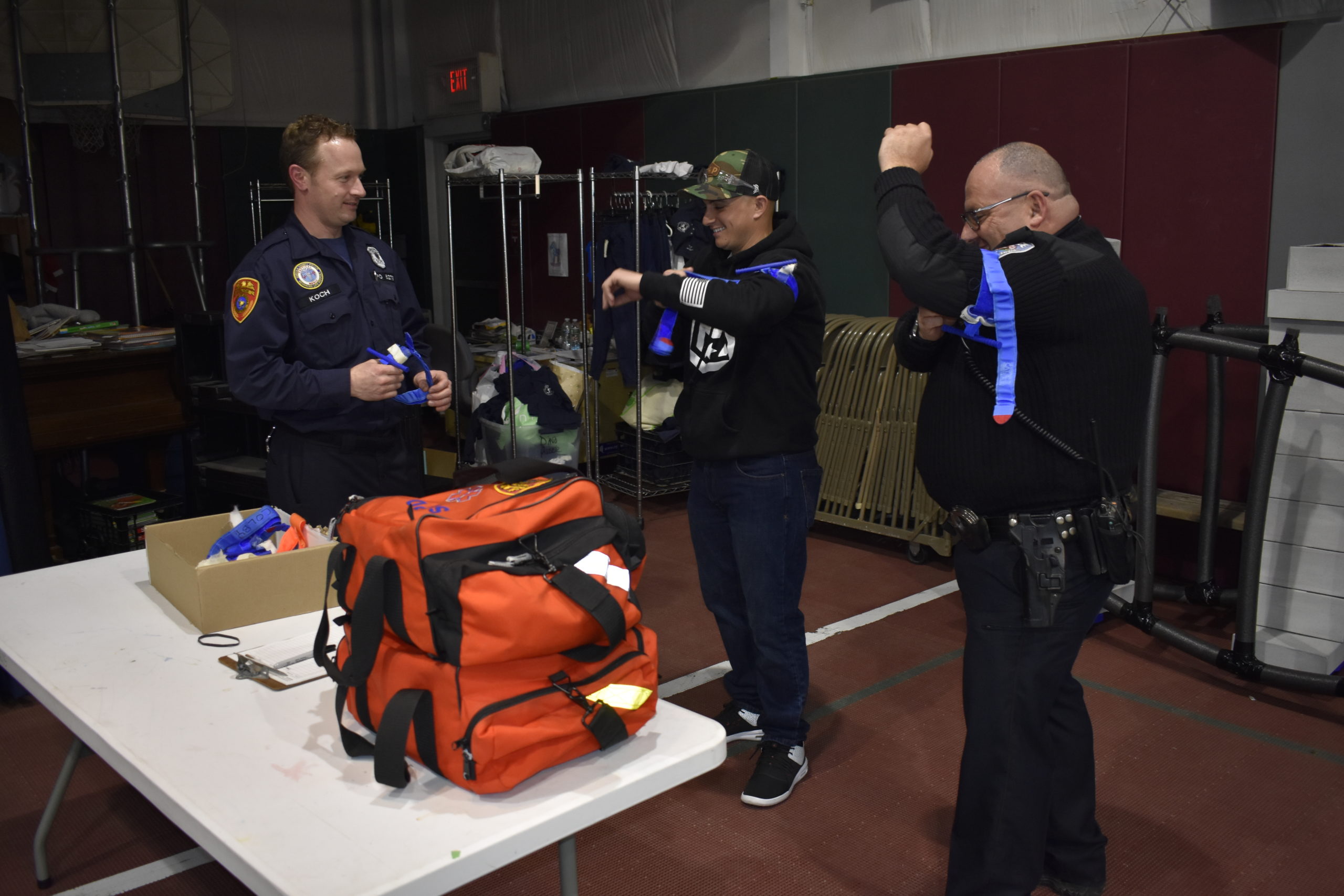 Brian Koch, left, discusses tourniquets with Southampton police officers as they practice using the devices, which apply pressure to a limb to restrict blood flow and prevent gunshot victims from bleeding out.