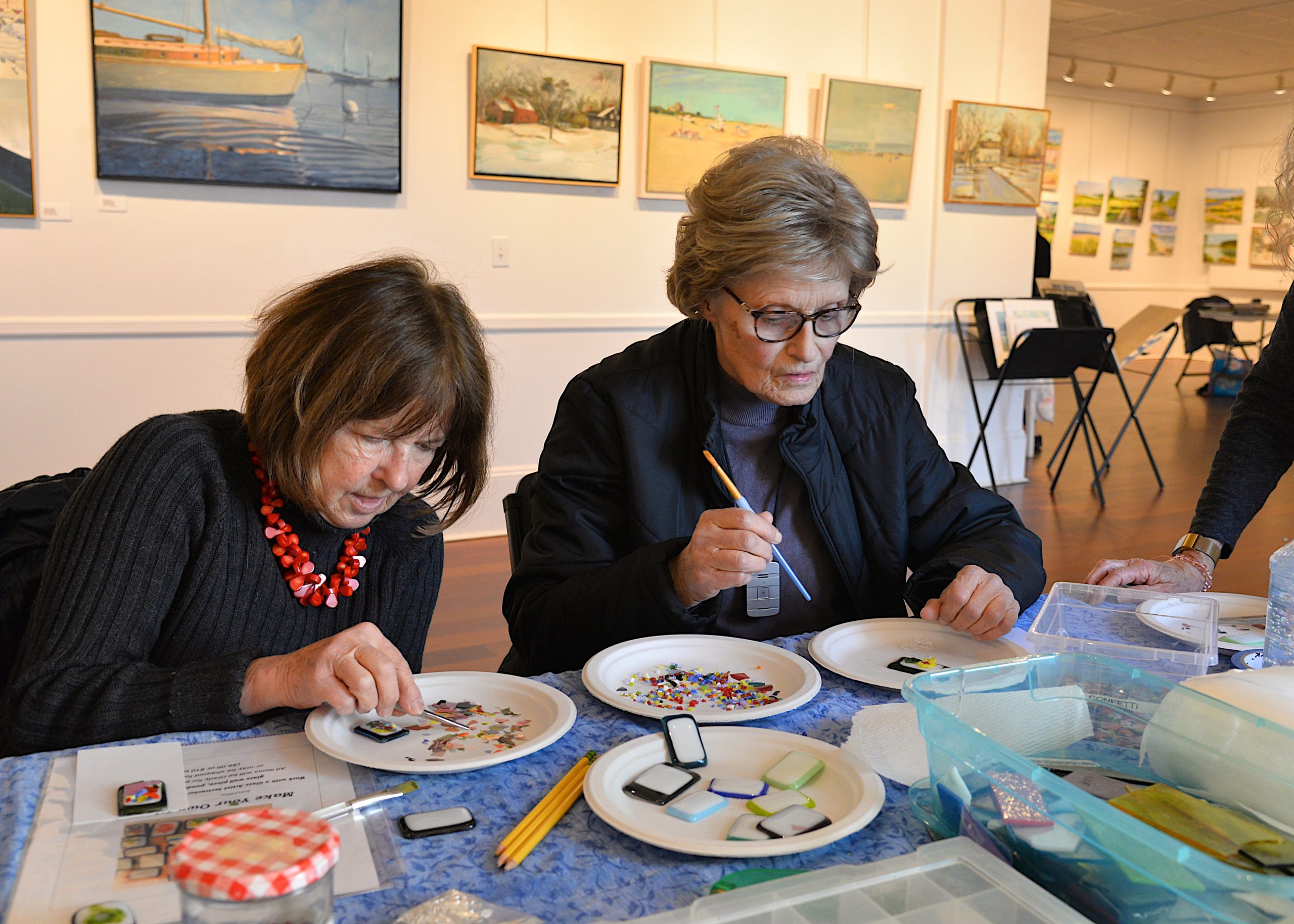 The Artists Alliance of East Hampton held an art exhibit at Ashawagh Hall this weekend, featuring then work of the Wednesday Group, Plein-Air artists using local scenery for inspiration There were also workshops in painting and glass fusion. Ursula Thomas and Annie Loris try their hand at learning glass fusing techniques. KYRIL BROMLEY 