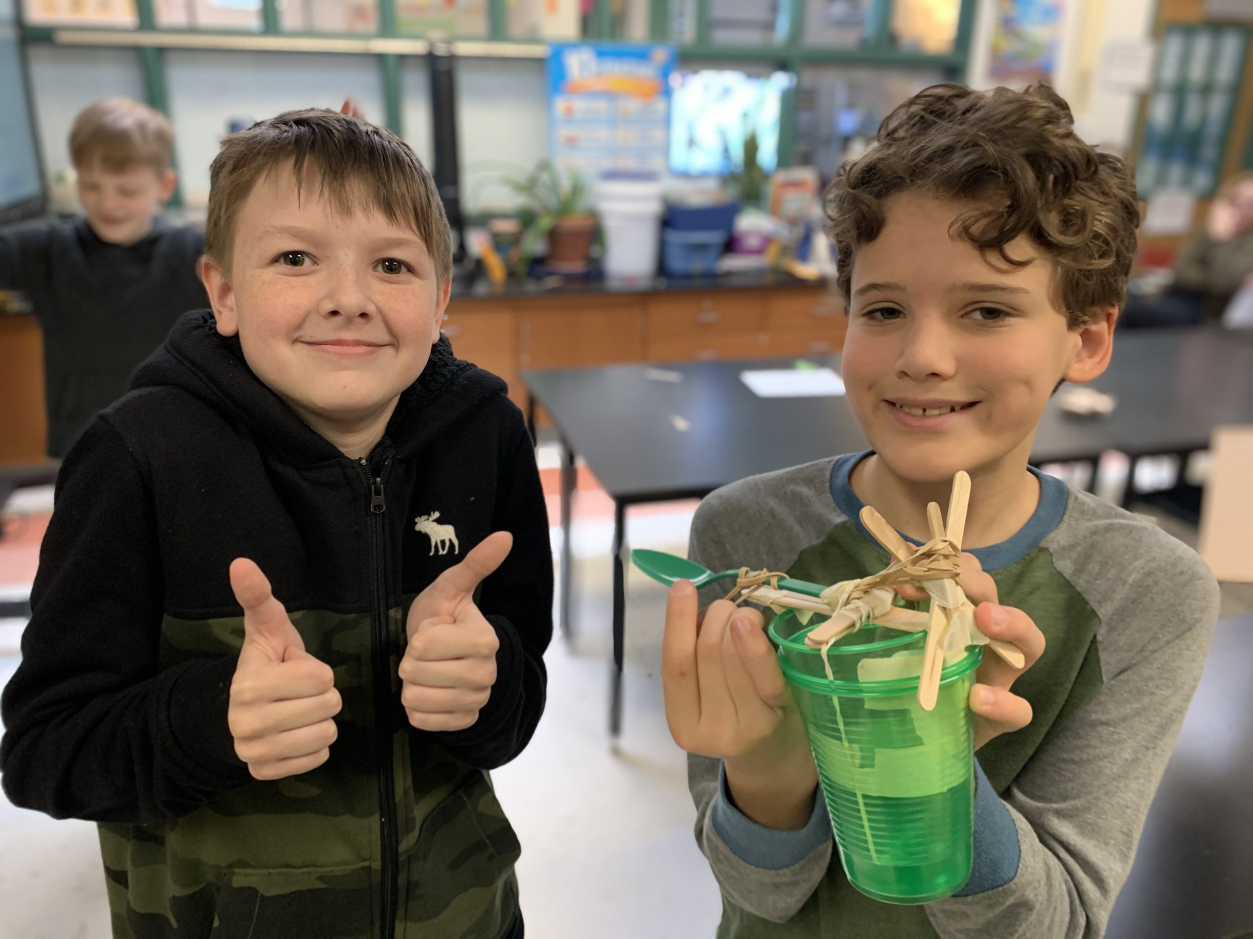 East Quogue Elementary School sixth graders are exploring how catapults changed warfare in ancient Greece by engineering their own catapults with a limited set of supplies.  Ari Firestein and Aidan Judd, right, with their design.