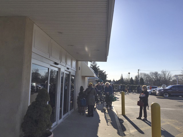 Seniors wait in line during special shopping hours at the Amagansett IGA.  KITTY MERRILL