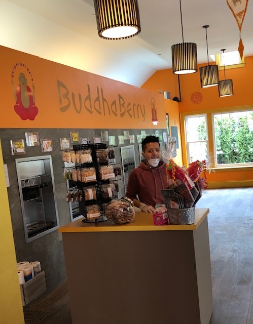 An employee at a new order station at Buddha Berry. 