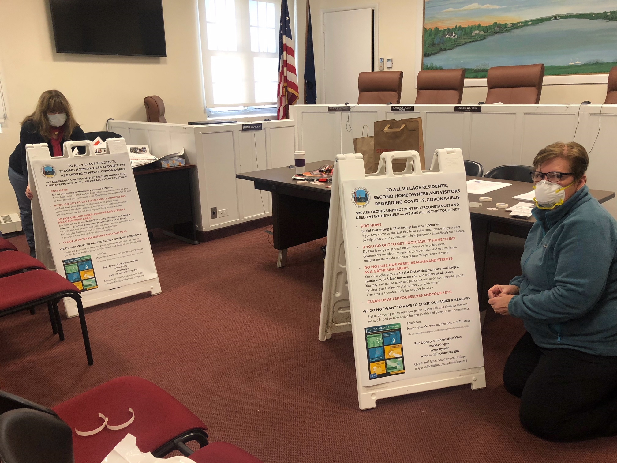 In Southampton Village, Julie Fitzgerald and Patricia Lederman worked on signs offering COVID-19 warnings and advice. 