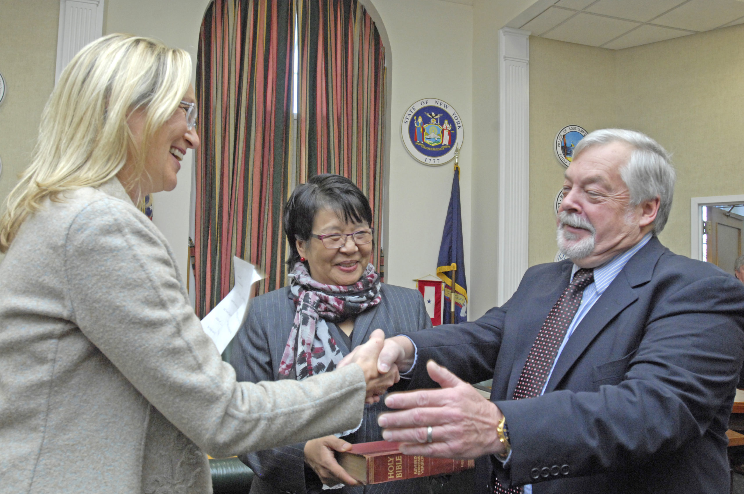 Suffolk County Legislator Bridget Fleming swears in Councilman John Bouvier for his first term in 2016. PRESS FILE