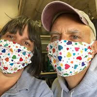 Diane and Phil Bucking in masks sewn from fabric used to make curtains for daughter, Kate's bedroom 20 years ago. Home from teh University of Notre Dame, Kate has since sewn over 60 masks for friends and family in Sag Harbor. 