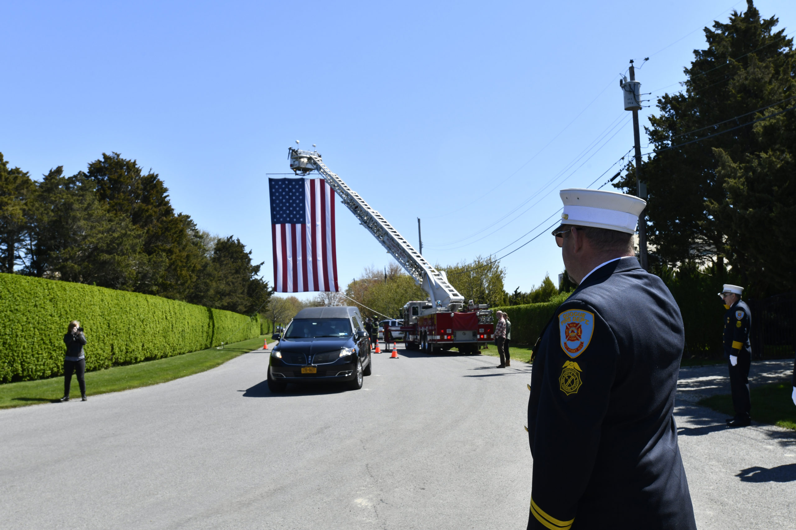 Members of the Quogue Fire Department line street heading to the home of George Mathys on May 13.  DANA SHAW