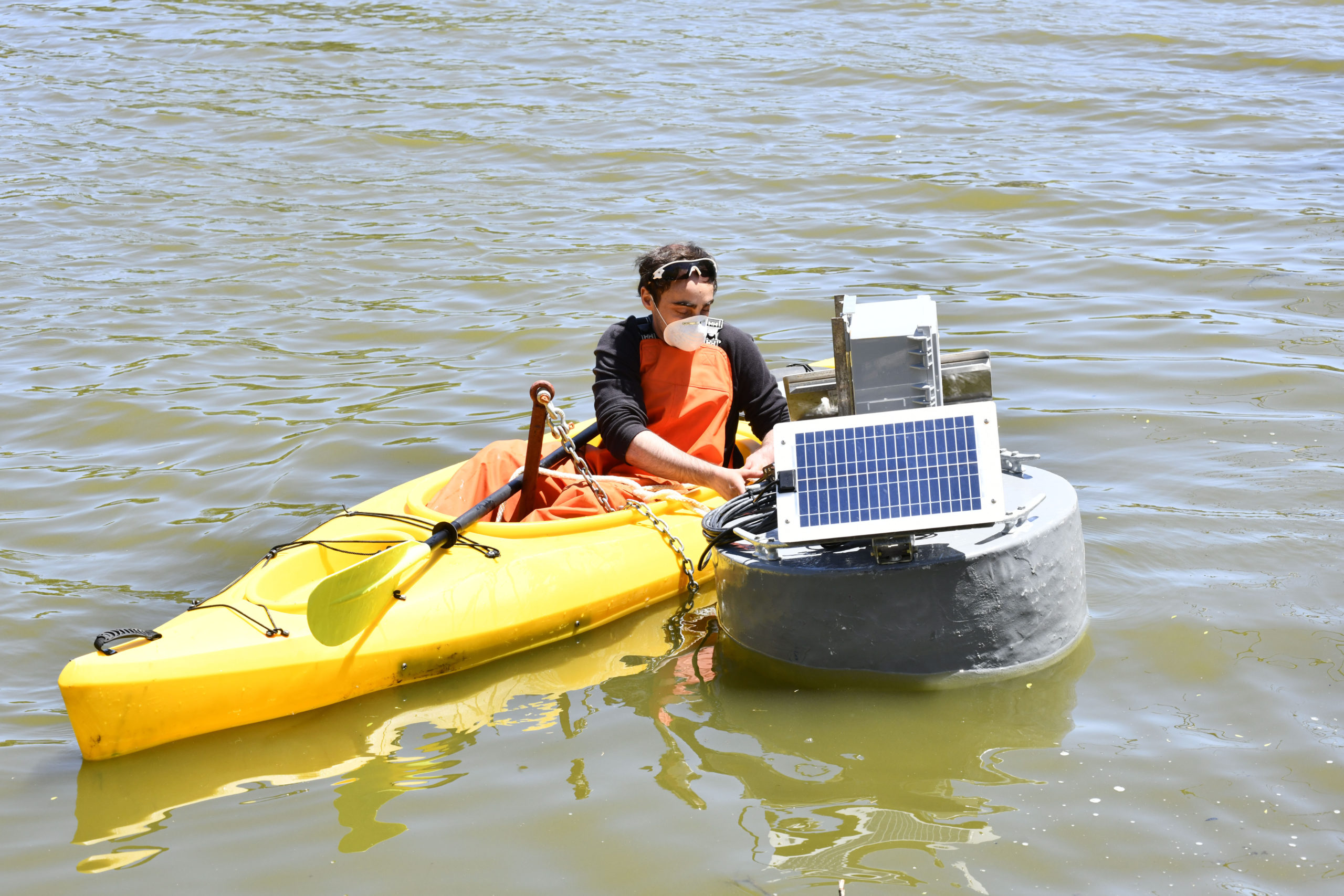 The real-time water quality monitoring buoy  is towed into the middle of Lake Agawam on Friday. DANA SHAW