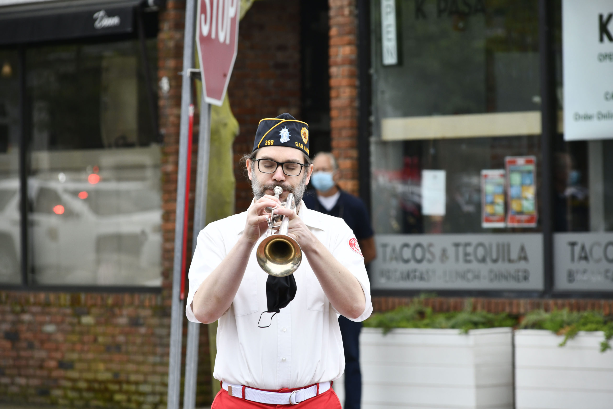 Alex Huberty plays Taps during Memorial Day observances in Sag Harbor on Monday.