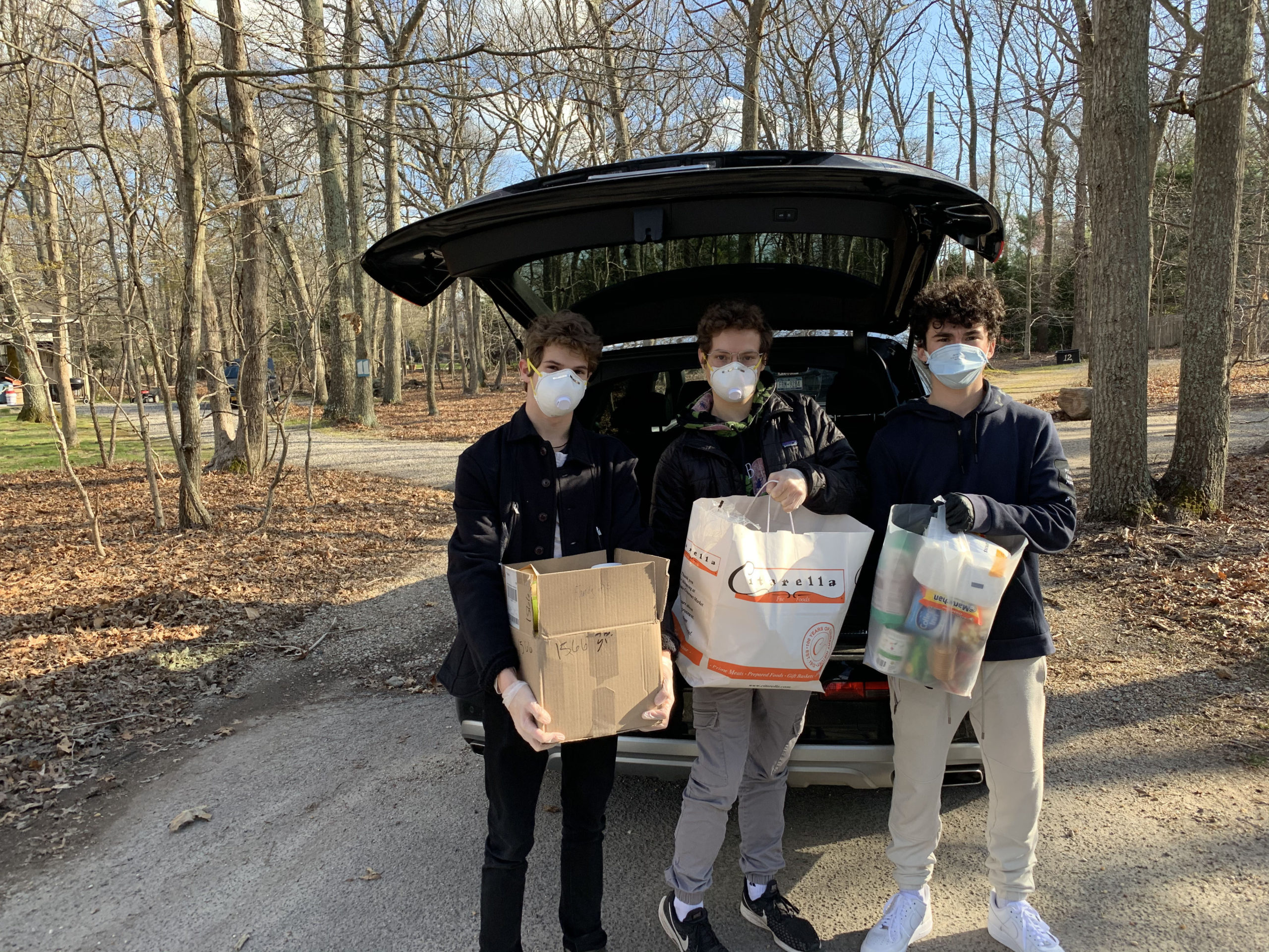 Ben Gleeman, Jonah Gleeman, and Ryan Spiegel, the founders of Doorstep Donations, with a recent pickup. COURTESY RYAN SPIEGEL