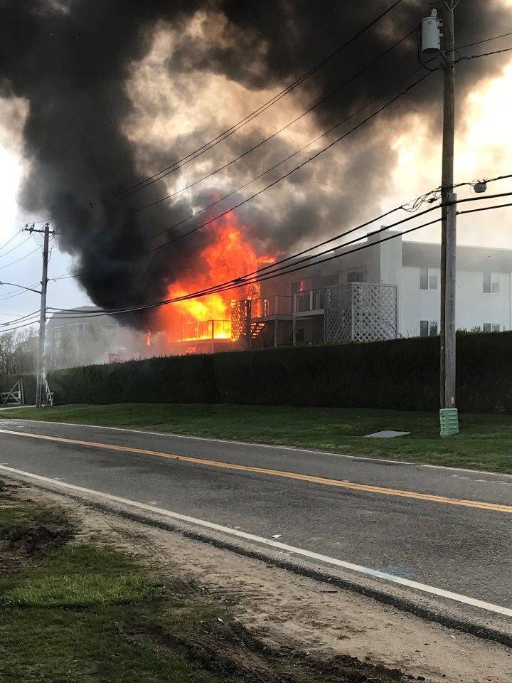 Fire rips through the Atlantic Bluffs complex on Old Montauk Highway in Montauk shortly before fire fighters arrive on the scene Saturday evening. 