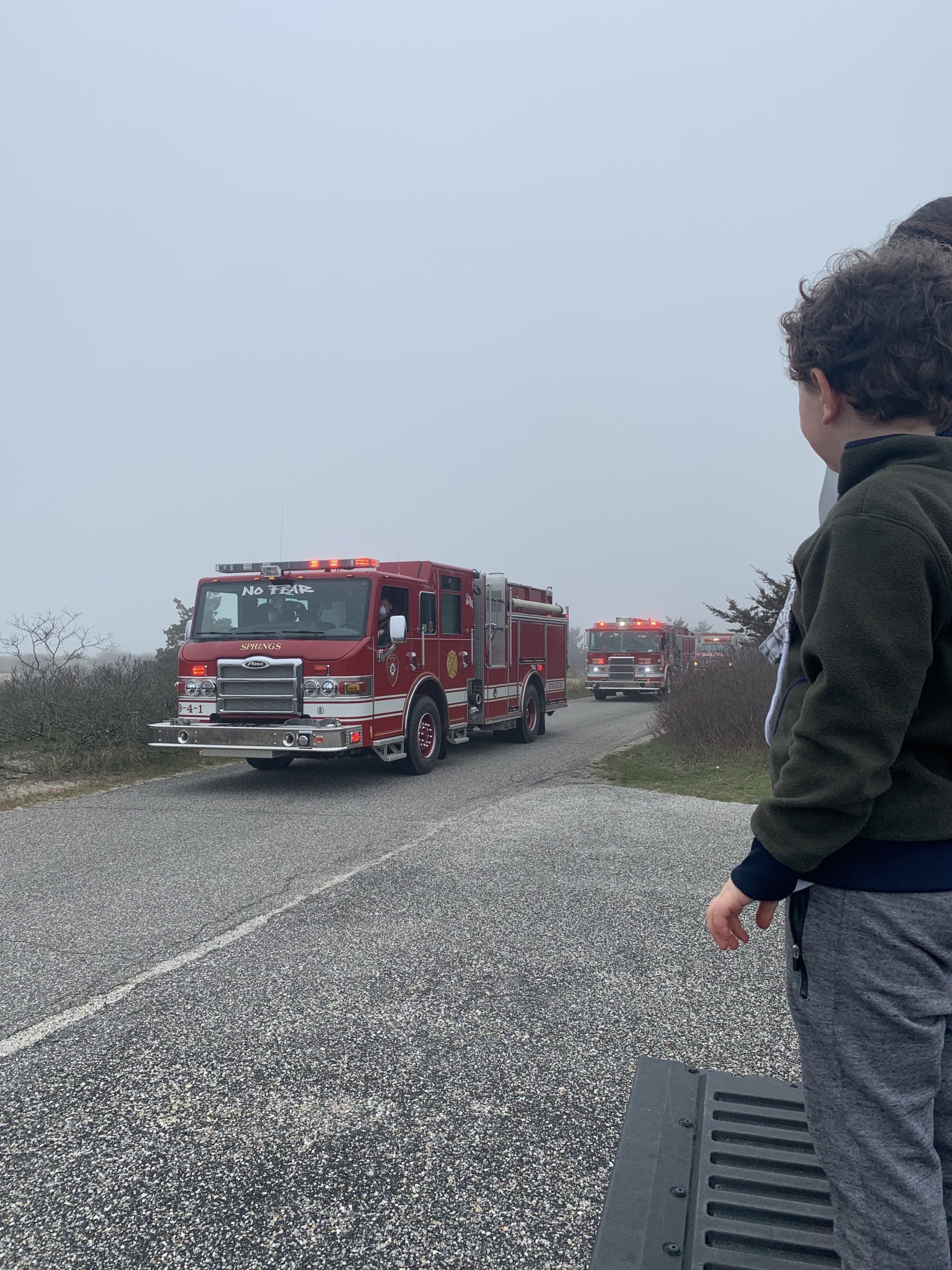 Volunteers with the Springs Fire Department lead a Spirit Drive at Maidstone Beach where students and families were encouraged to maintain social distance while waving to teachers and administrators. 