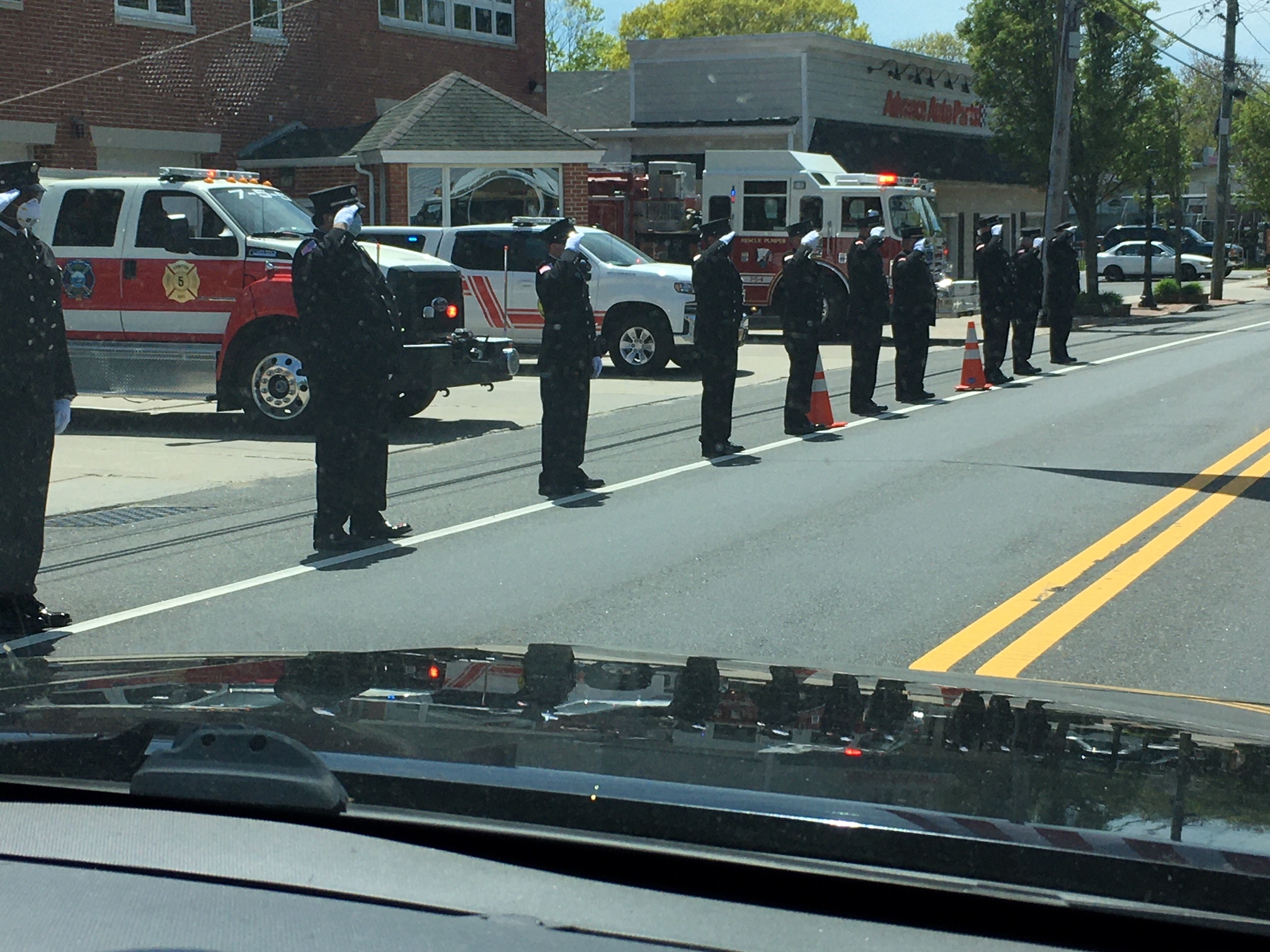 Firefighters saluted the funeral porcession as it passed. LORI SIDOR
