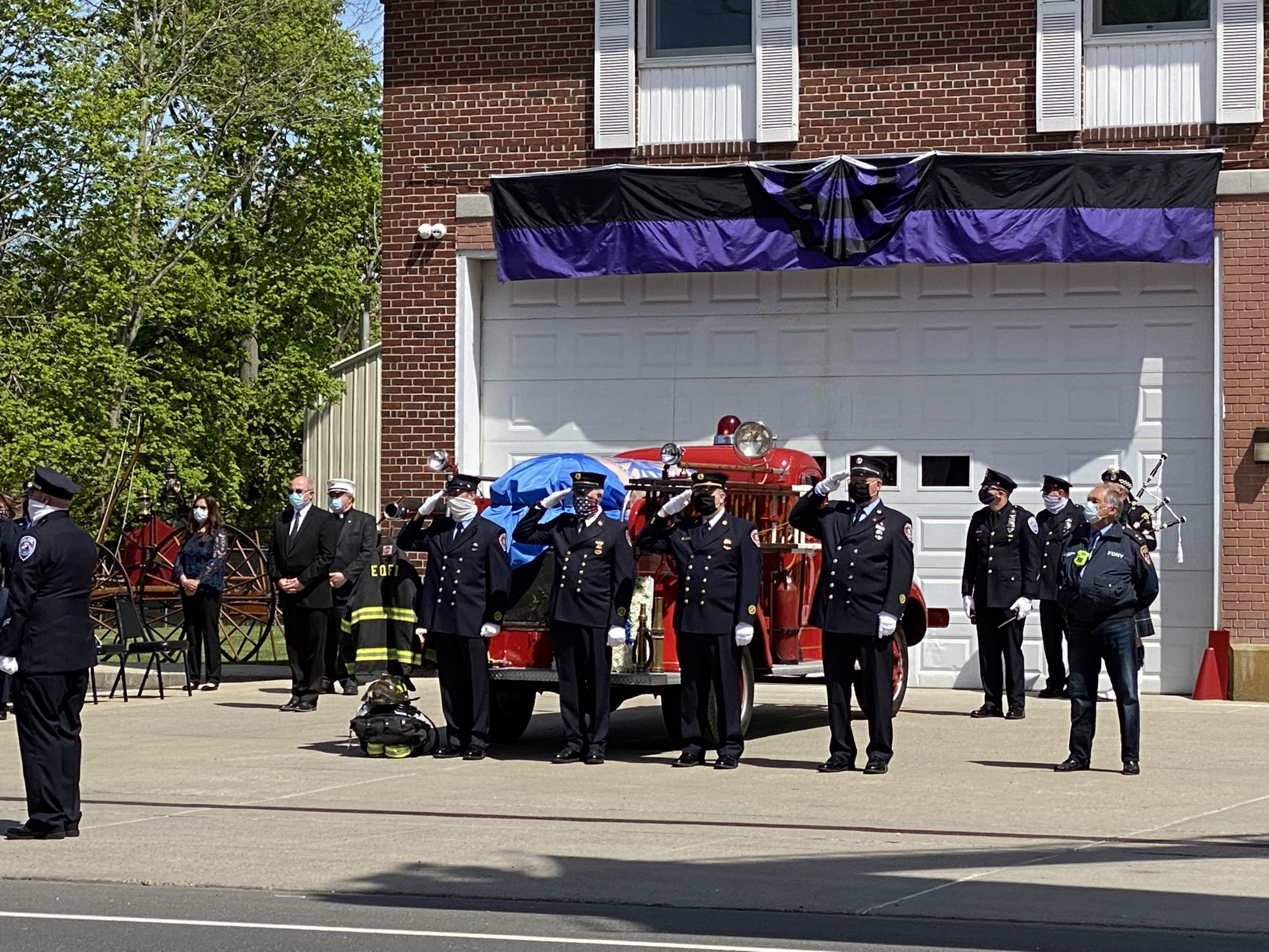 Montauk Highway was lined with people and fire and rescue trucks from all over the East End for the procession and service for Mark Sidor at the East Quogue Firehouse on Saturday afternoon.  DANA SHAW