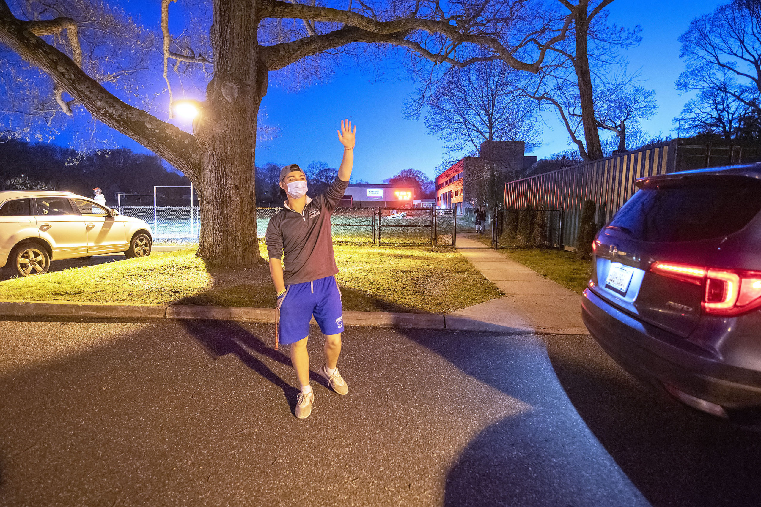 Senior Gabriel Ramundo waves to his fellow classmates during a parade in tribute to the Pierson High School senior athletes in the Montauk Avenue parking lot behind the school on Friday night.