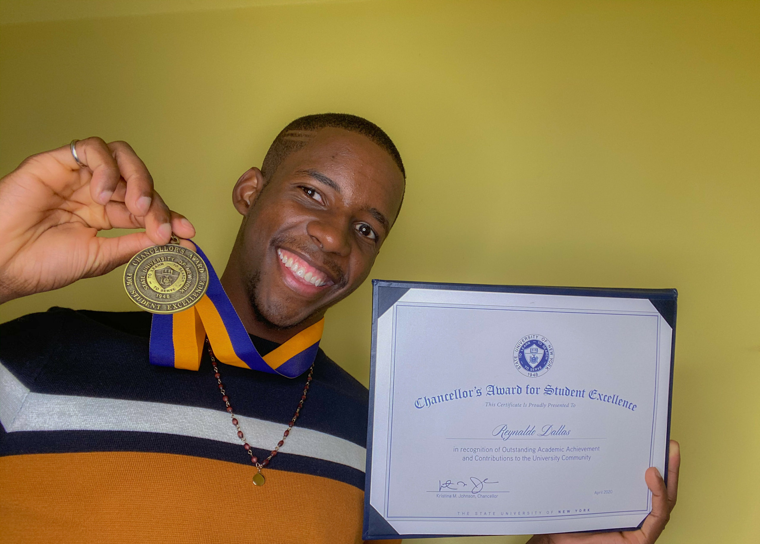 Reynaldo Dallas with his SUNY Chancellor Award for Student Excellence. 