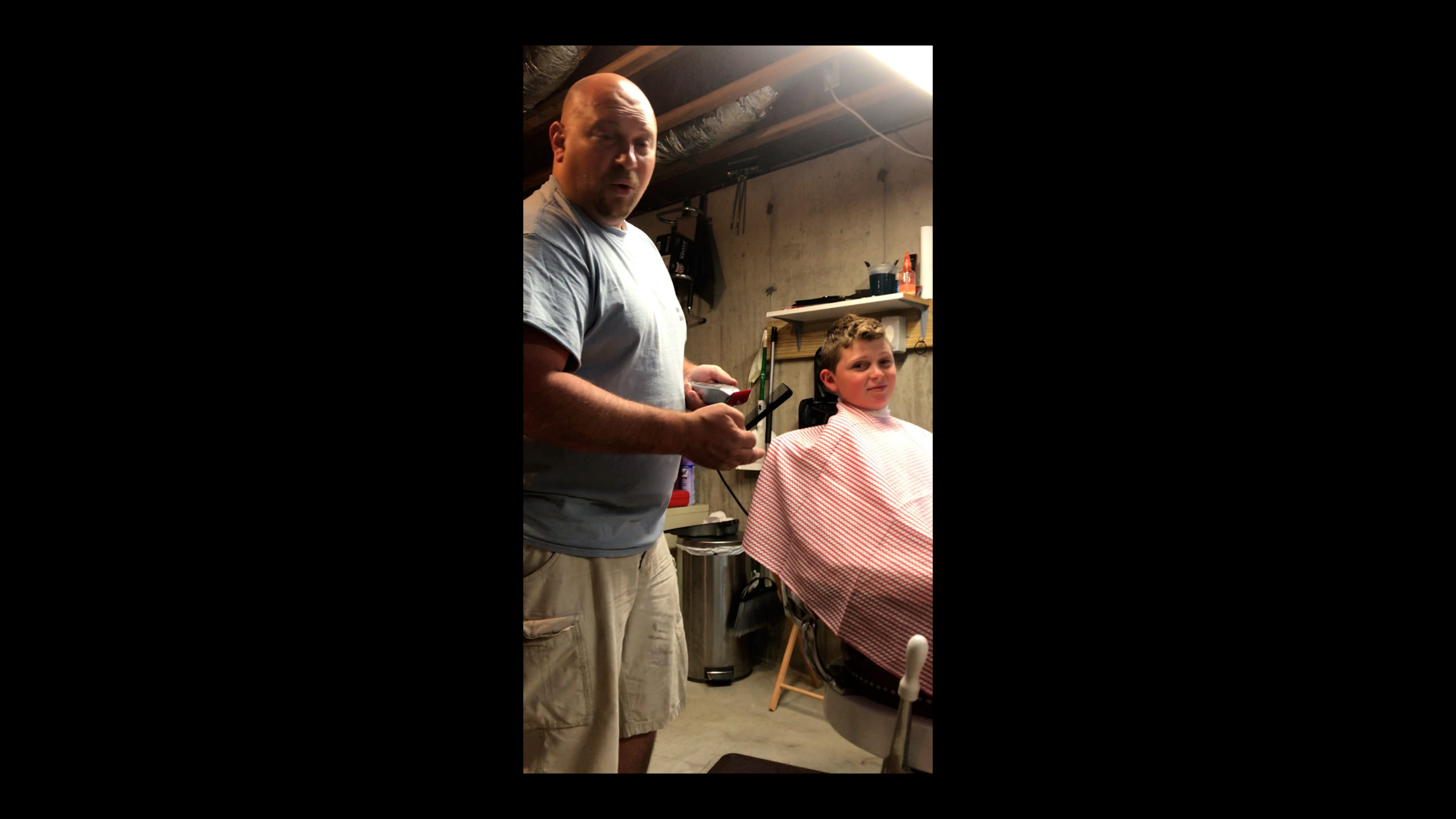 Nick Mazzeo gives a home haircut to Dominic Mazzeo.