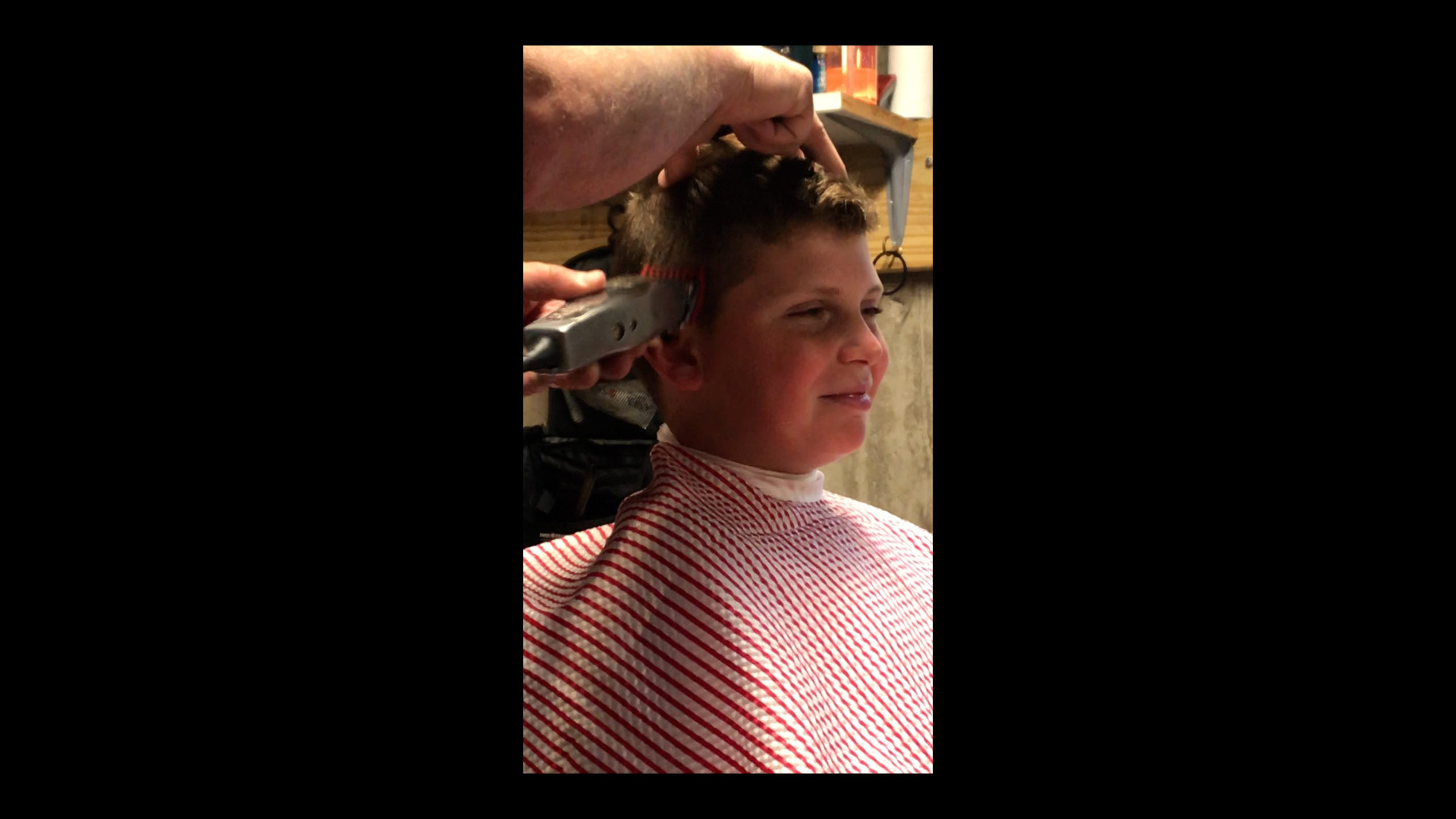 Nick Mazzeo gives a home haircut to Dominic Mazzeo.