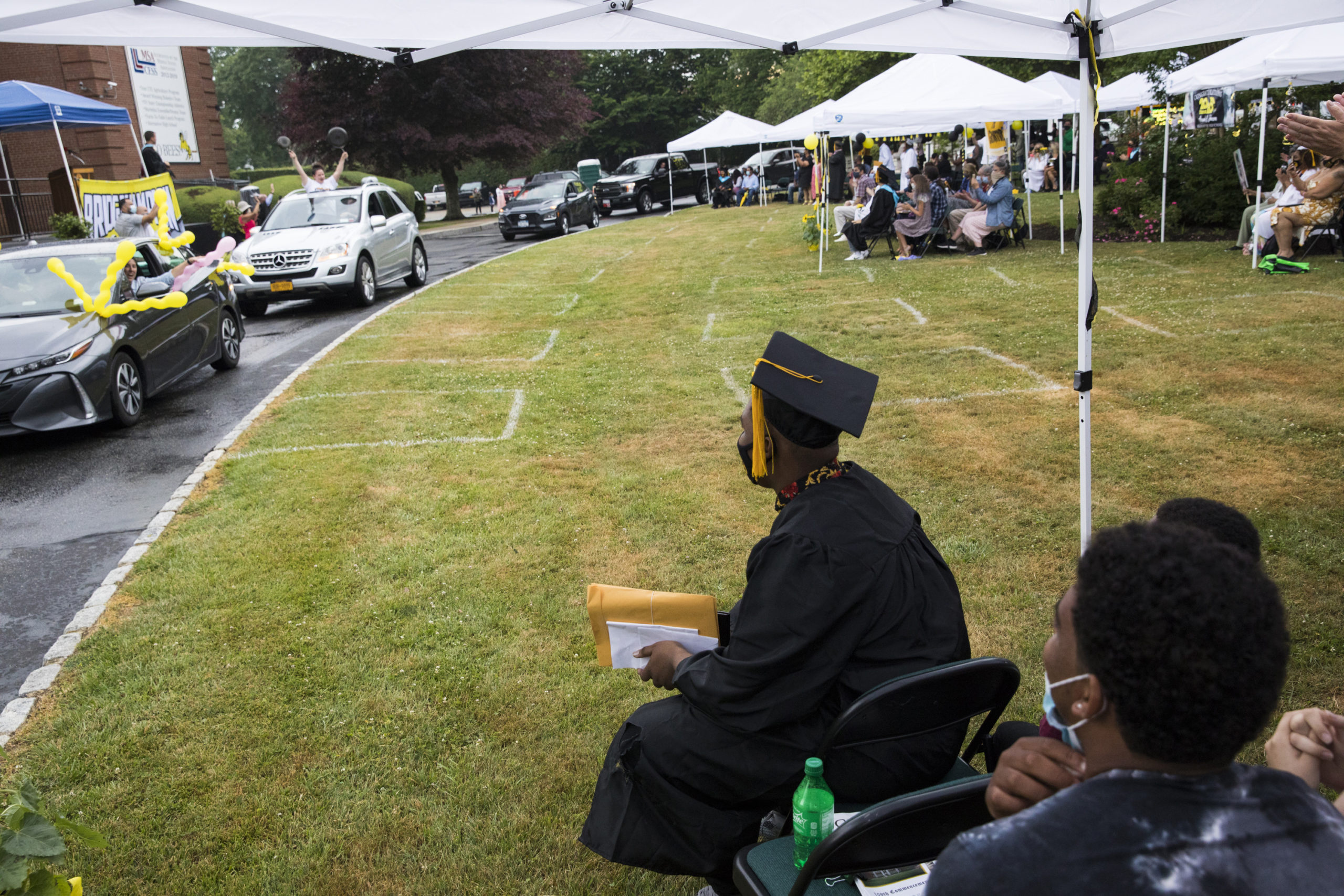 Cars parade through the driveway of the Bridgehampton School at the conclusion of graduation on Saturday.