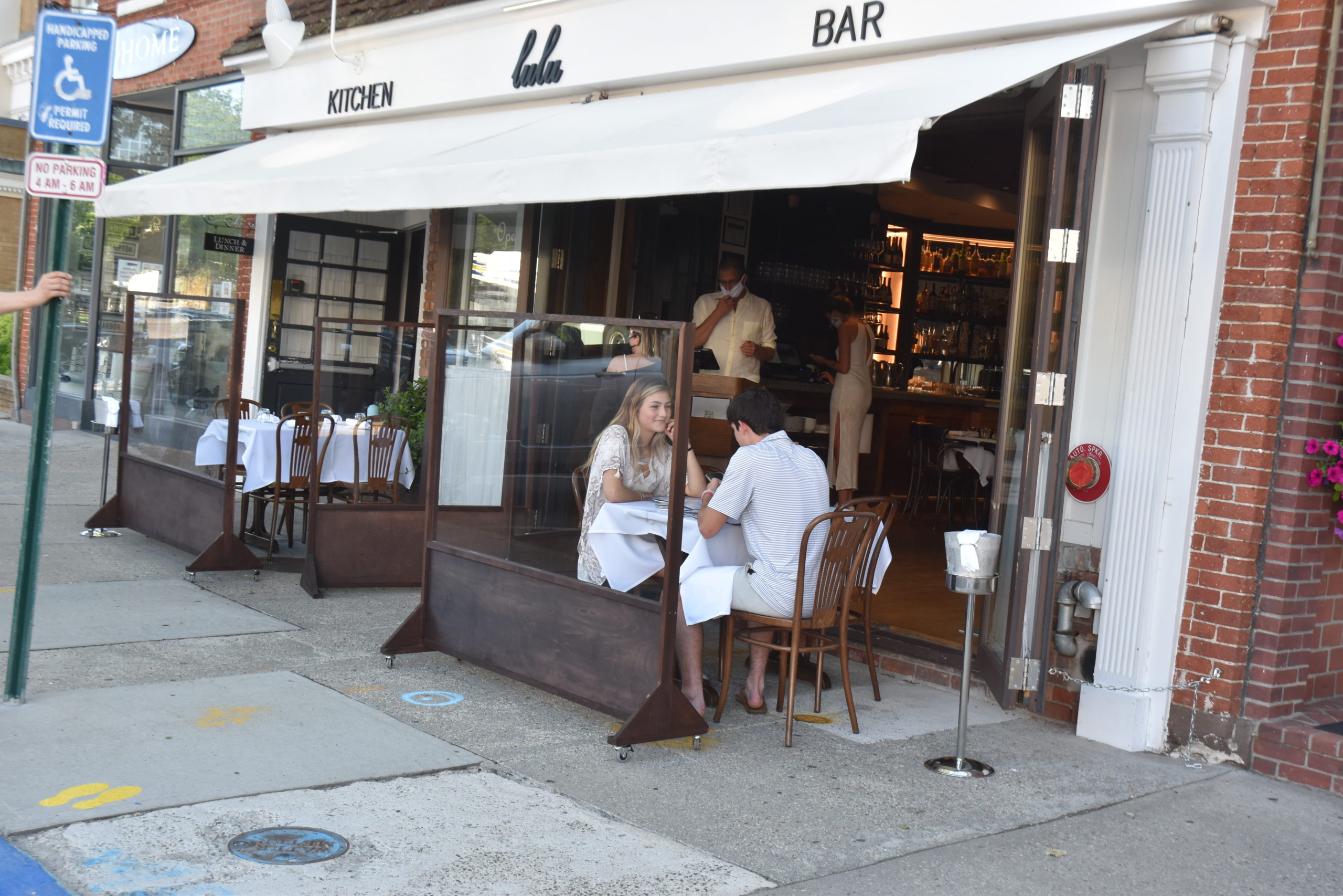 Diners at one of two tables in front of Lulu restaurant in Sag Harbor. STEPHEN J. KOTZ