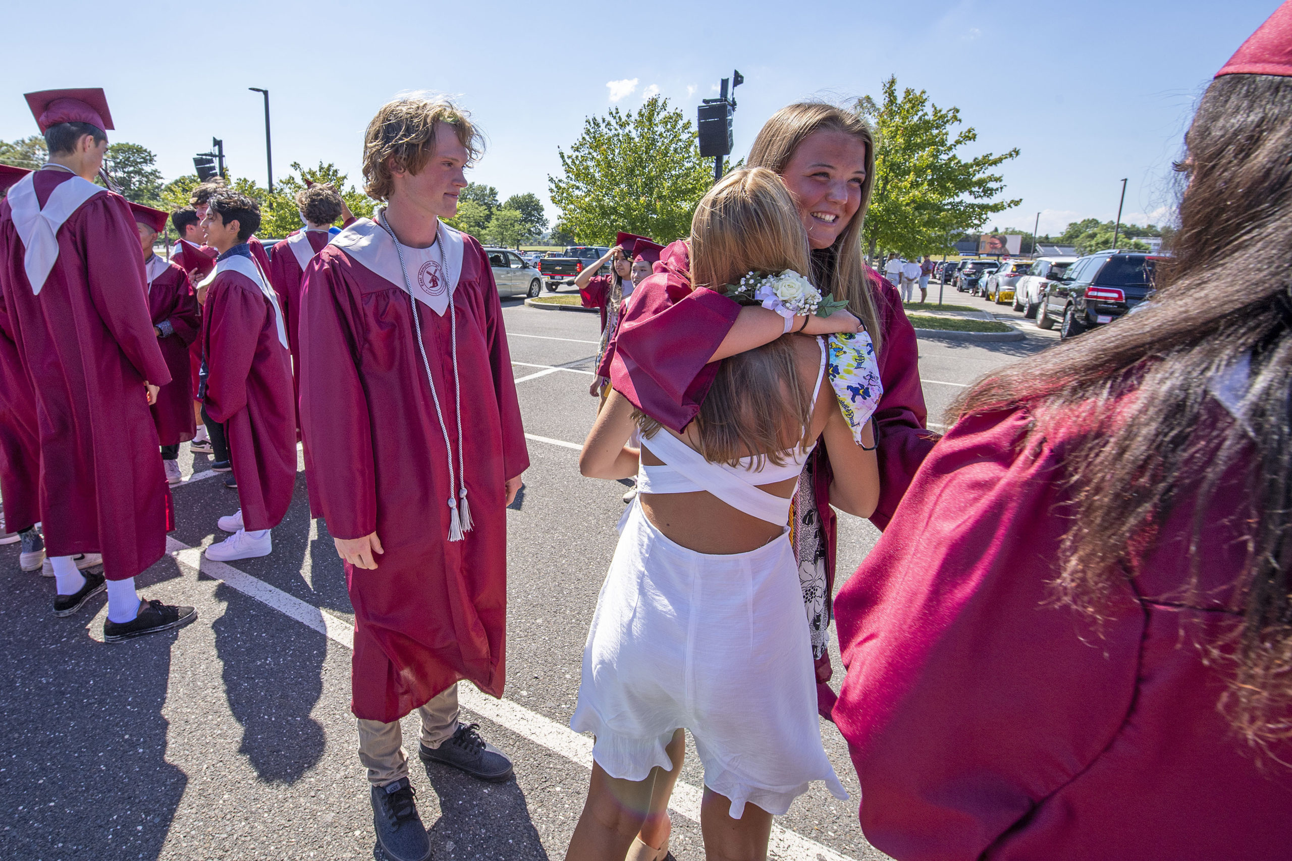 East Hampton High School Seniors traded hugs and smiles as they got ready to participate in the 2020 graduation ceremony at the East Hampton High School on Friday.