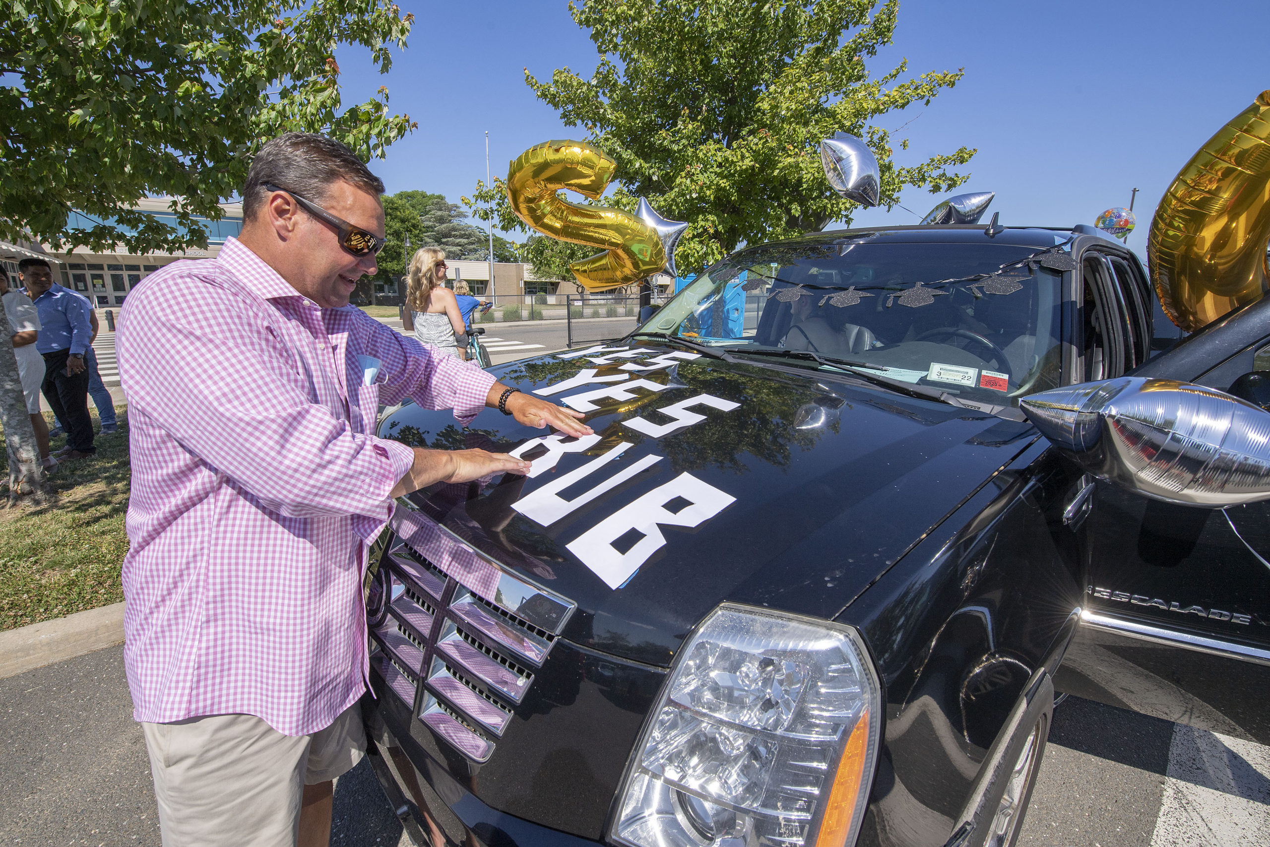 Brian Villante shows some Bonac pride as he decorates his car in the parking lot prior to the 2020 graduation ceremony at the East Hampton High School on Friday.