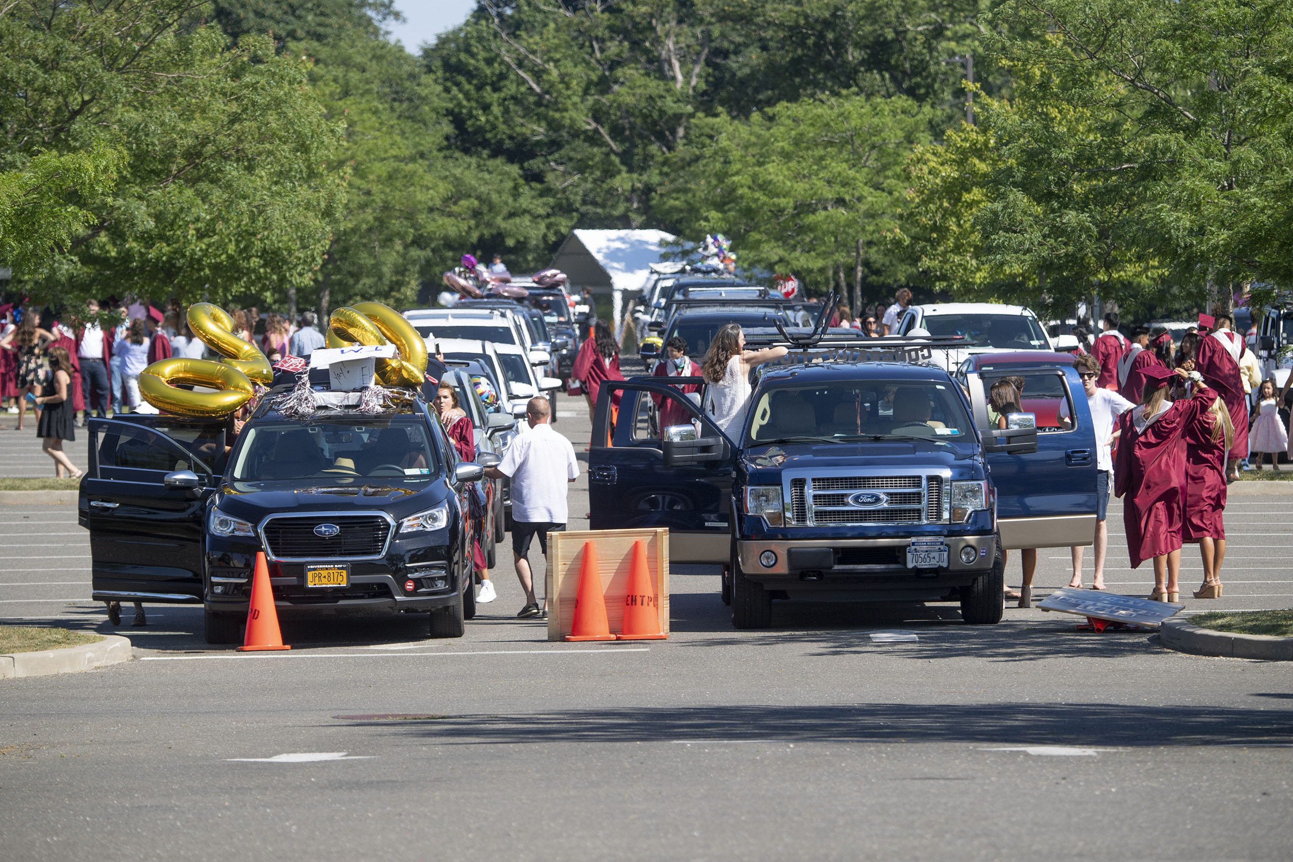 Cars line up in the parking lot by district as the seniors' families get ready to participate in the 2020 graduation ceremony at the East Hampton High School on Friday.