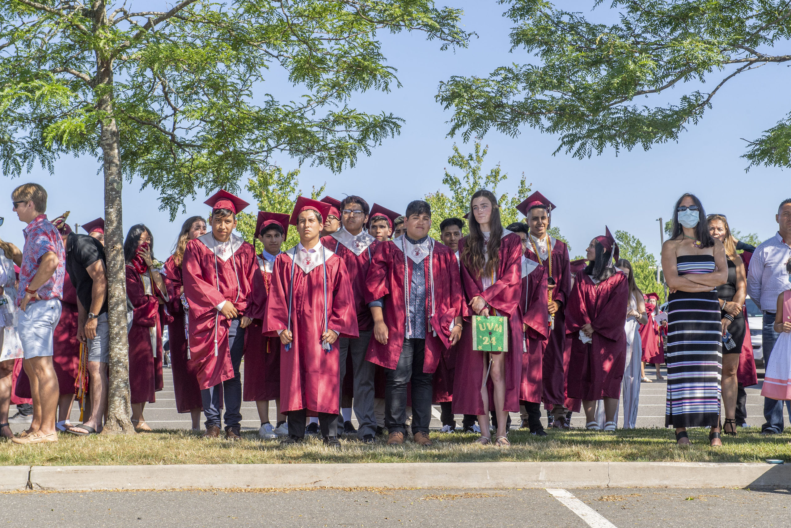 Seniors and their families watched the ceremony from the shade of some trees in the parking lot during the 2020 graduation ceremony at the East Hampton High School on Friday.