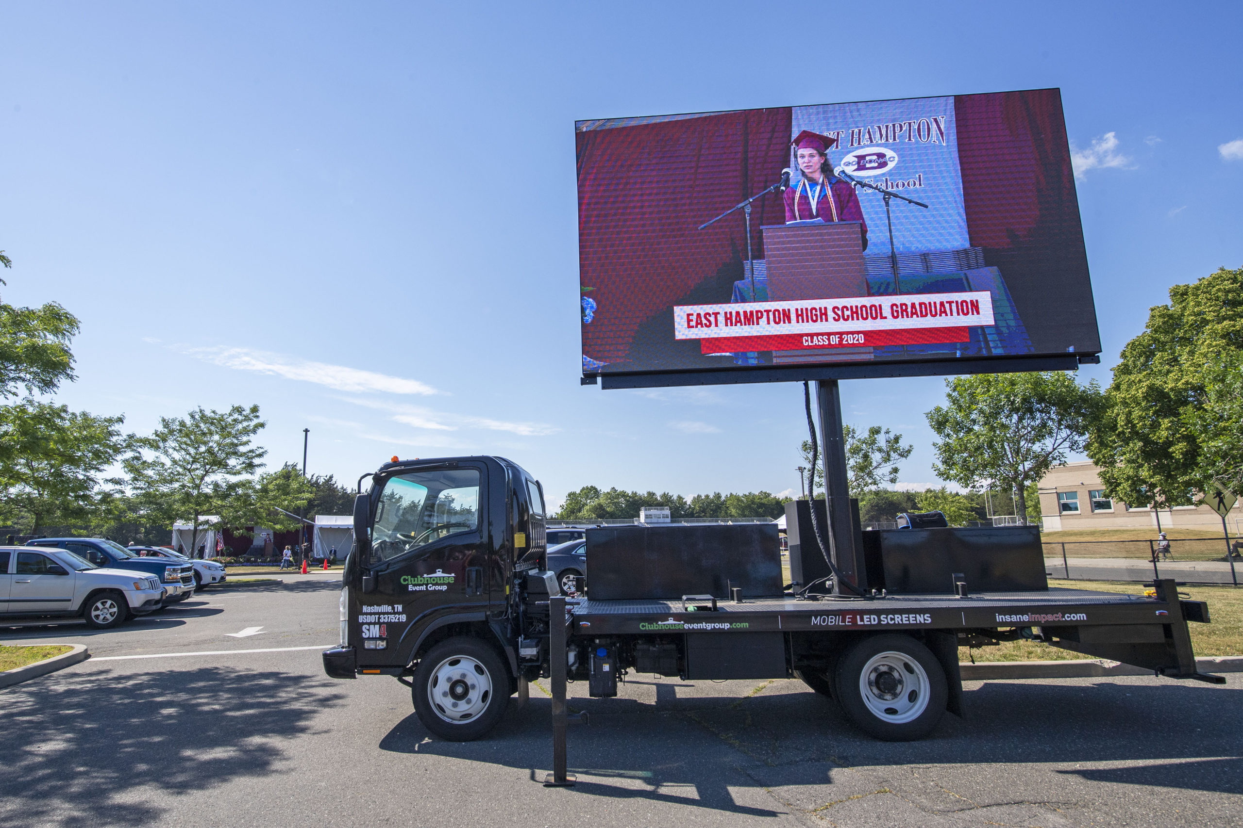 Families in their vehicles were able to watch on a mobile LED screen as East Hampton High School Senior Valedictorian Samantha Prince speaks during the 2020 graduation ceremony at the East Hampton High School on Friday. 