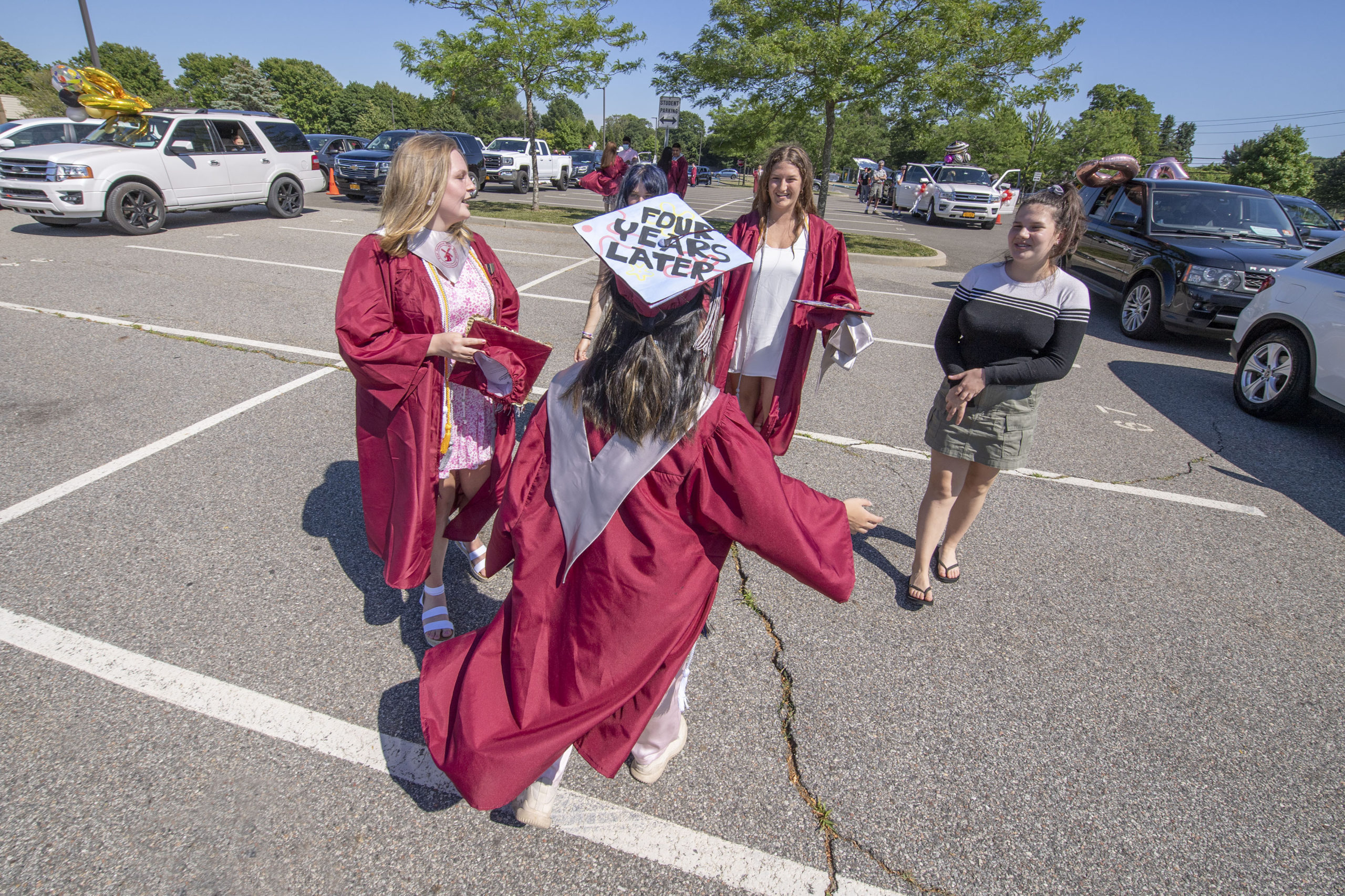 East Hampton High School Senior Han Le greets her classmates in the parking lot as she gets ready to participate in the 2020 graduation ceremony at the East Hampton High School on Friday.