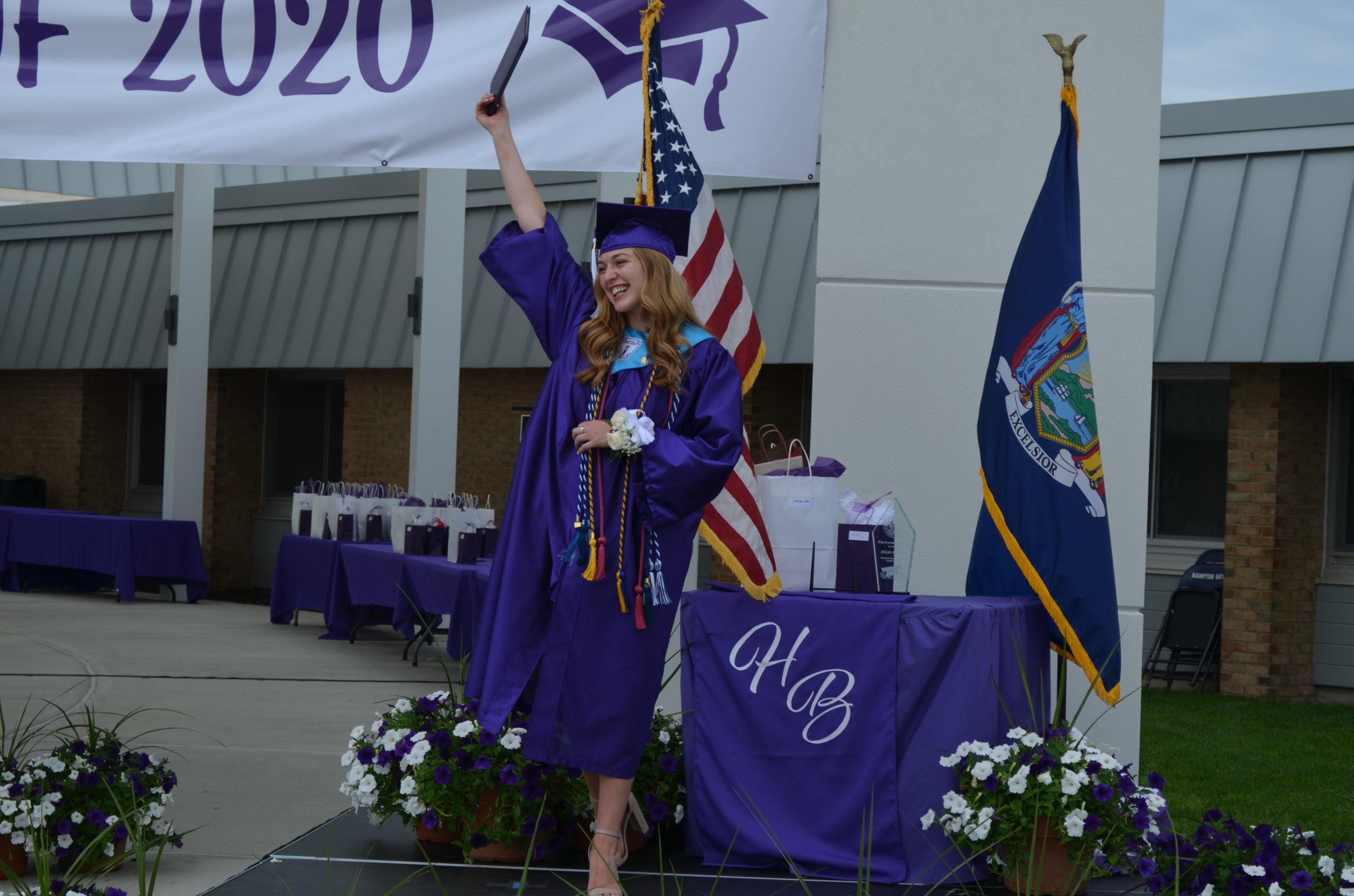 Julia Heming holds up her diploma to show it to the crowd in excitement. 