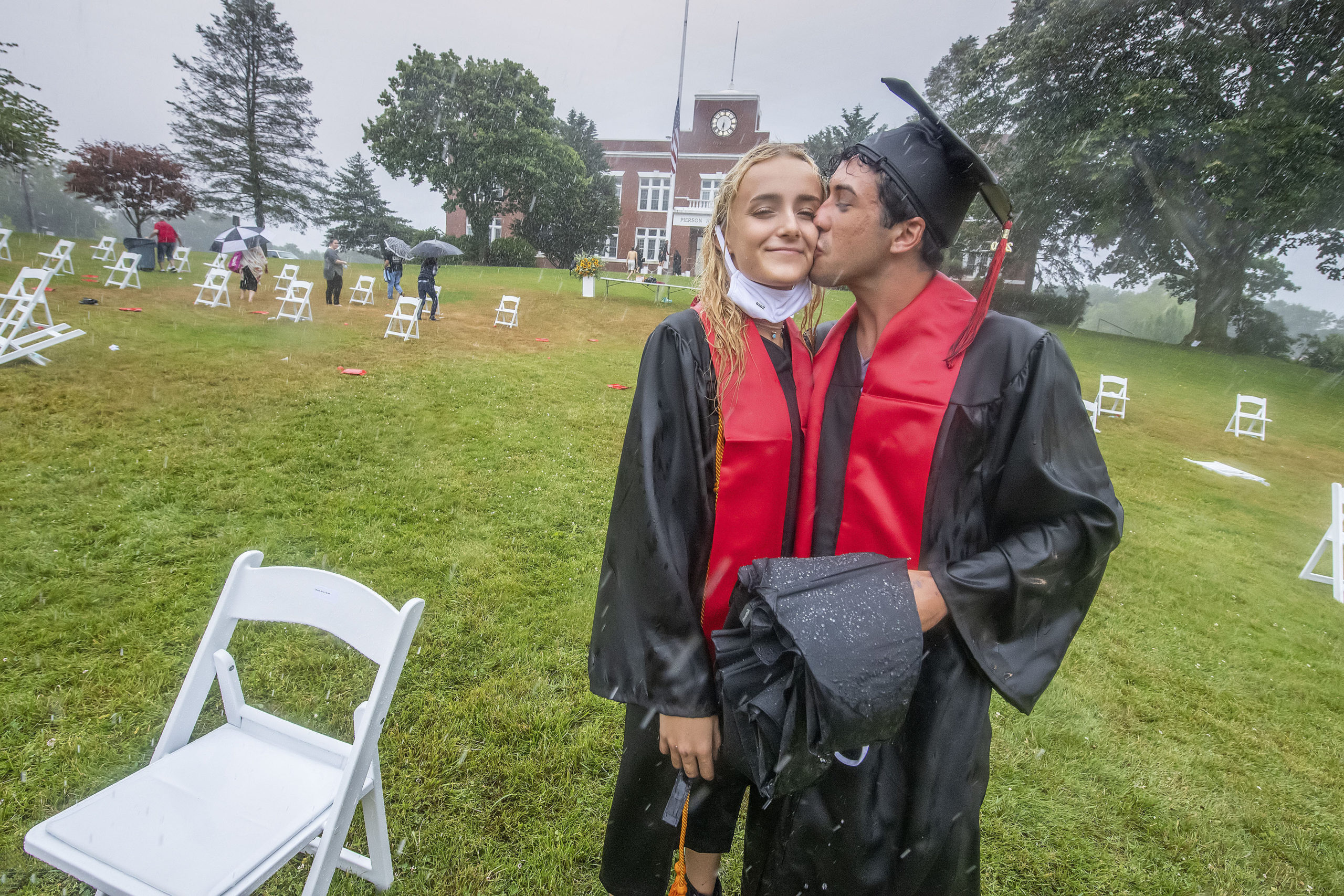 Ellie Borzilleri gets a kiss from classmate Patrick Chisholm following the Pierson High School 2020 Commencement Ceremony at Pierson High School on Saturday.
