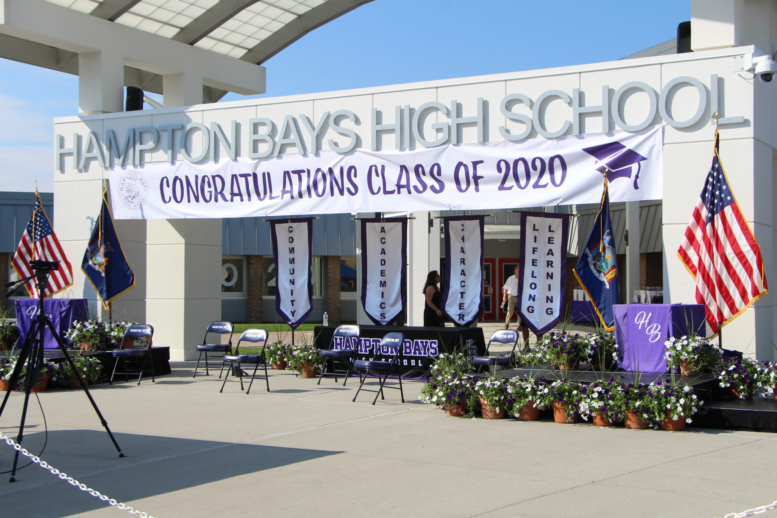 The set up of the Hampton Byas graduation, under the front enterance. Both daises had flowers and flags to make it look celebratory. 