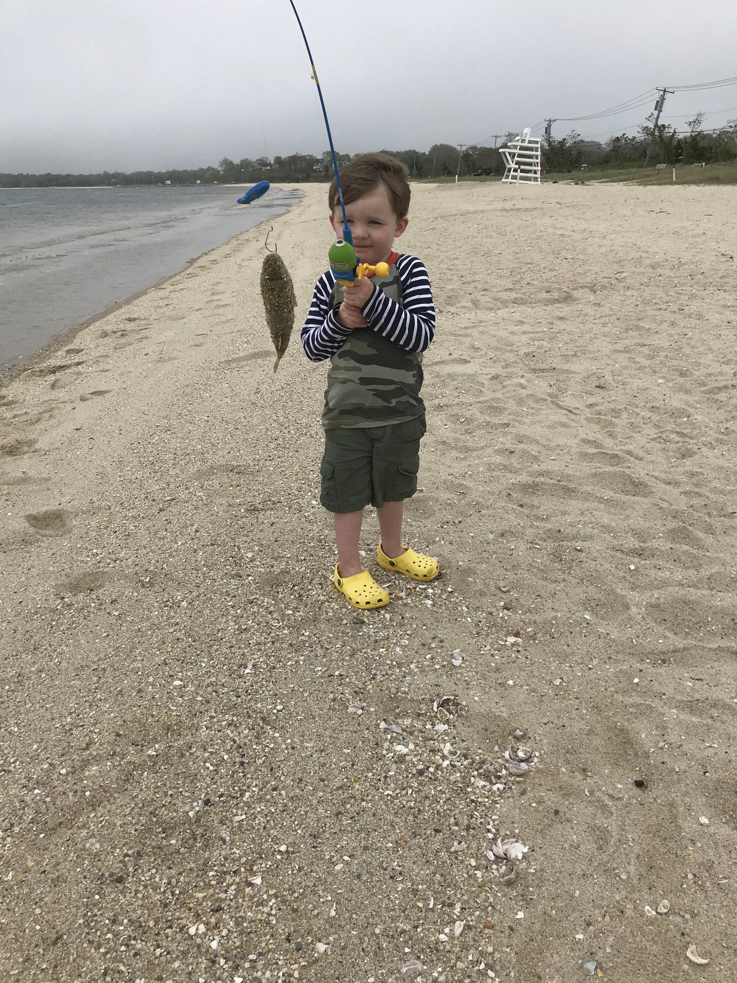 Three-year-old Henry Schubert from Huntington,  recently caught his first fish on the first cast on Long Beach while visiting his grandfather Mark Haslinger in Bay Point.  COURTESY MARK HASLINGER