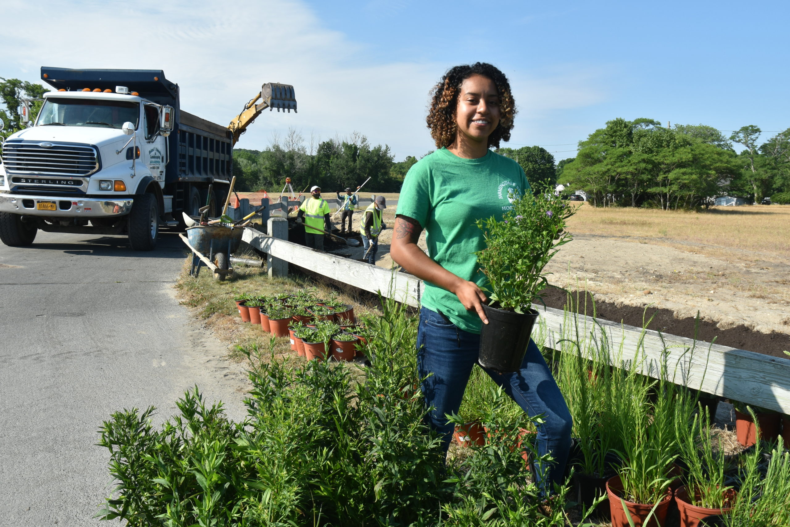 Cassandra Castano, a landscape ecologist with Nelson, Pope & Voorhis, with some of the plants used in the village's first rain gardens. STEPHEN J. KOTZ