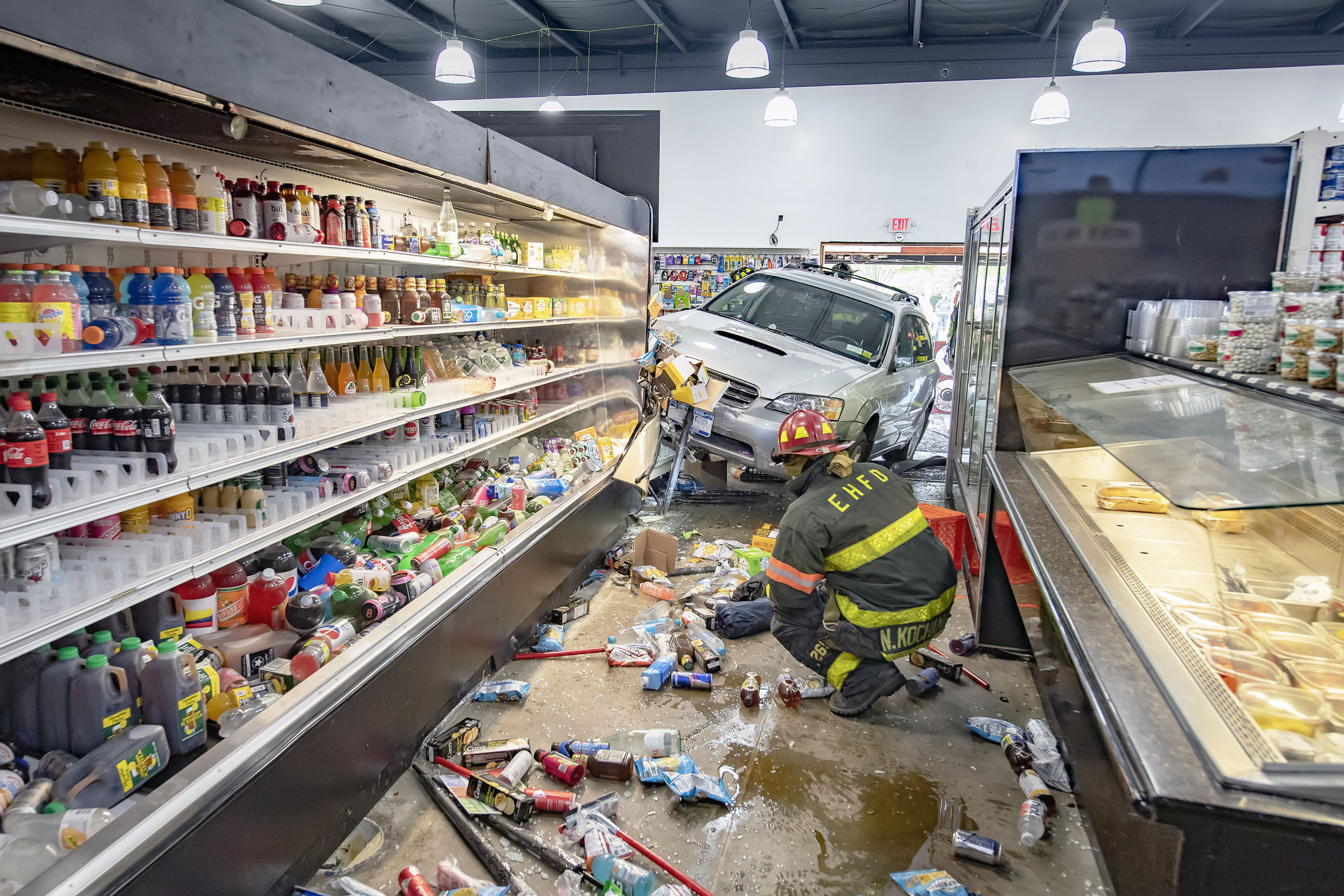 Two people suffered minor injuries when an car smashed through the front of the East Hampton Market on Race Lane. 