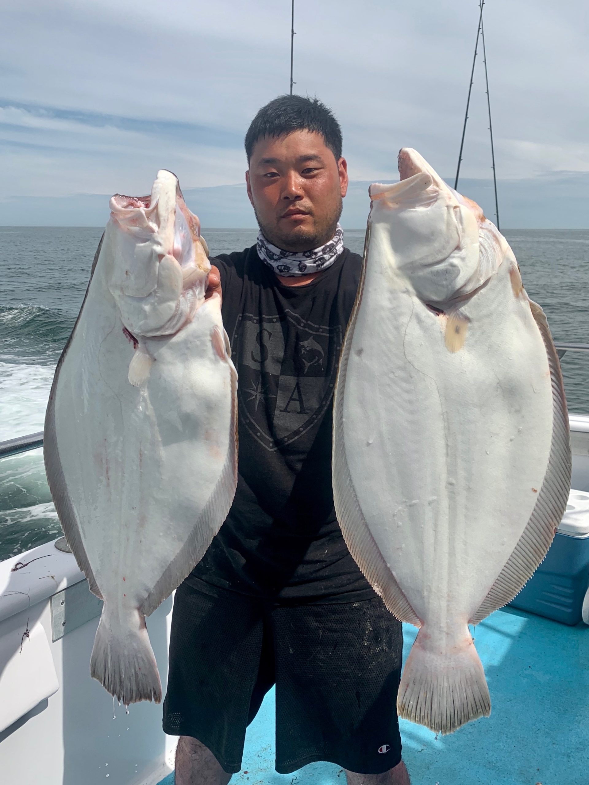 Eric Su decked this pair of big fluke while fishing aboard the Miss Montauk recently. 