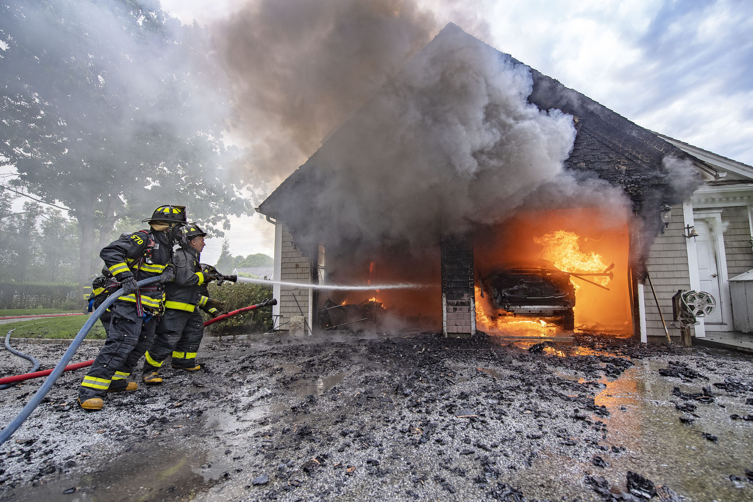 East Hampton Fire Department volunteers contained a garage fire on Sunday afternoon before it spread to the rest of a Roberts Lane home. 