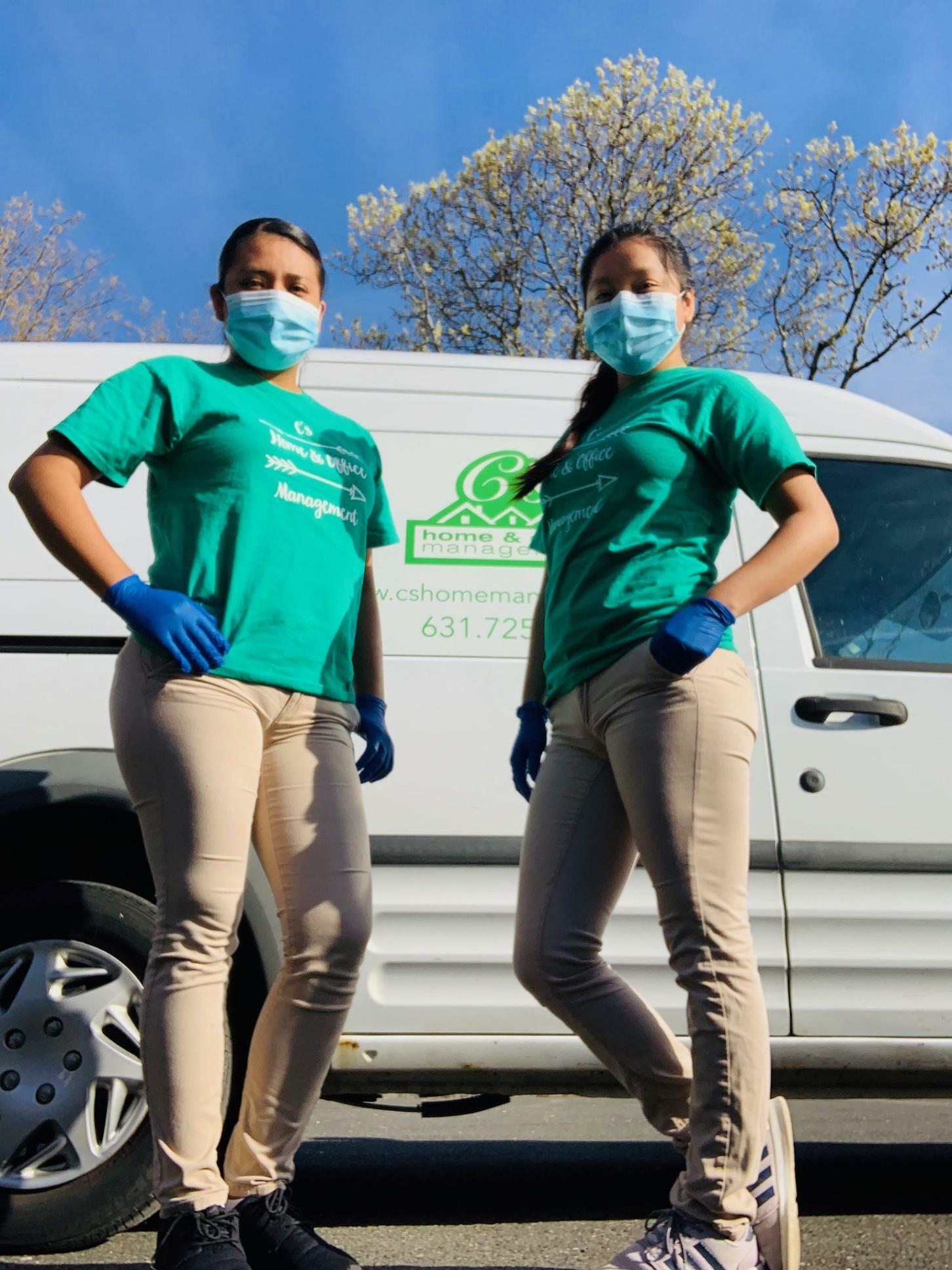 Jessie and Jocelyn of C's Home & Office Management sport masks and gloves on the job.