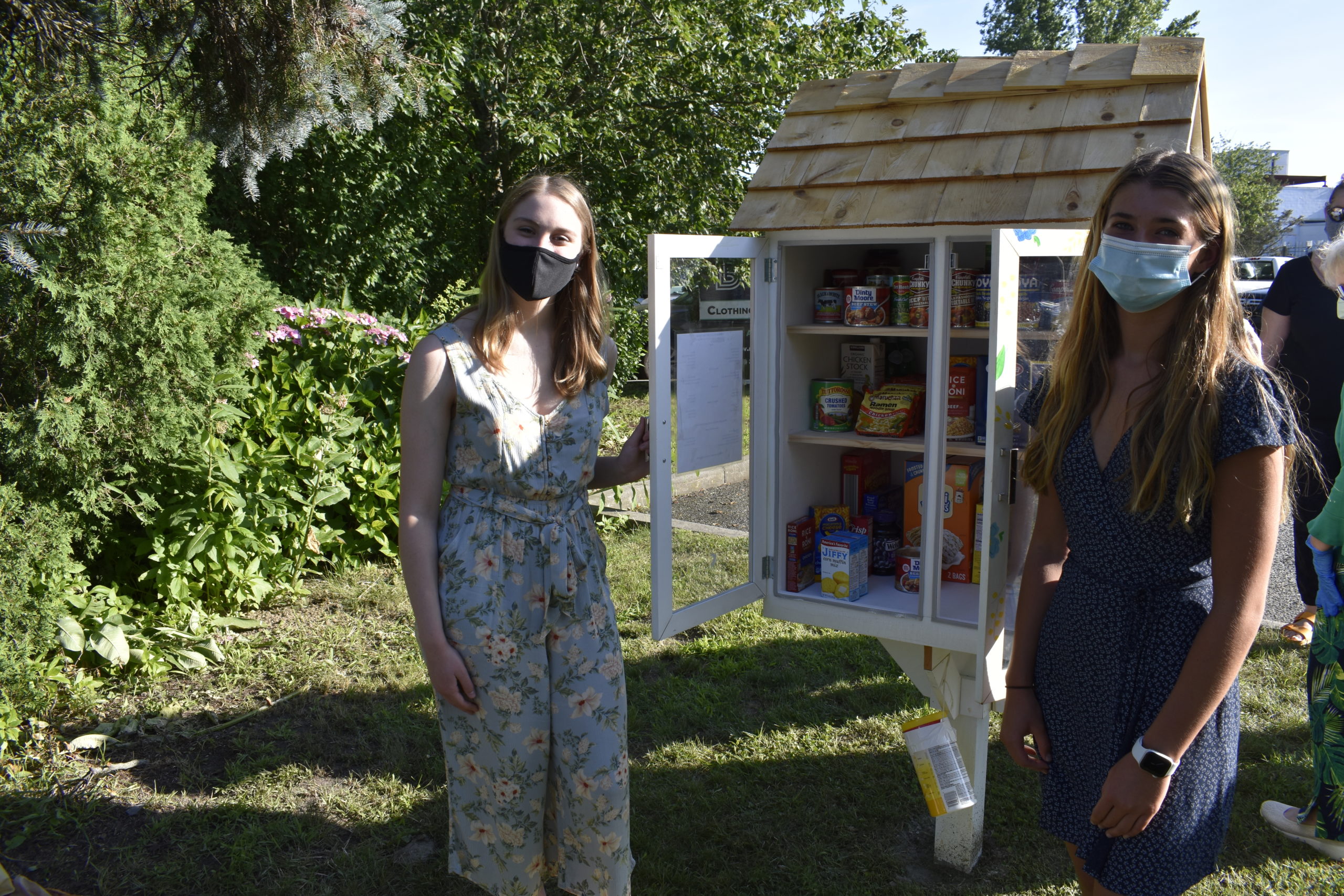 Alie Fitt and Fainne Sheehan with the new Westhampton Beach Little Free Pantry that they worked to establish.