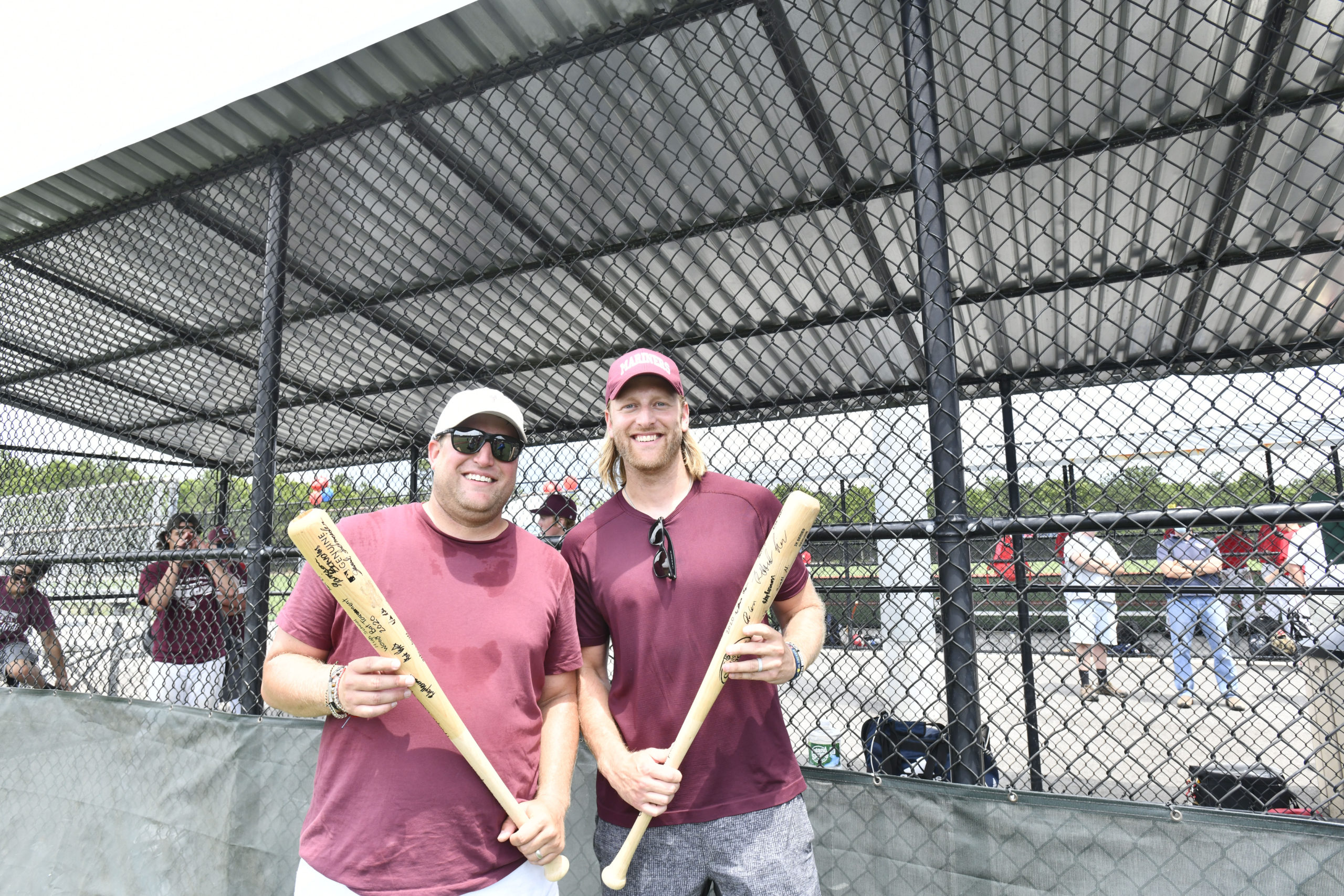 Mariner coaches Zach and Nick Epley with bats that the team signed.  DANA SHAW