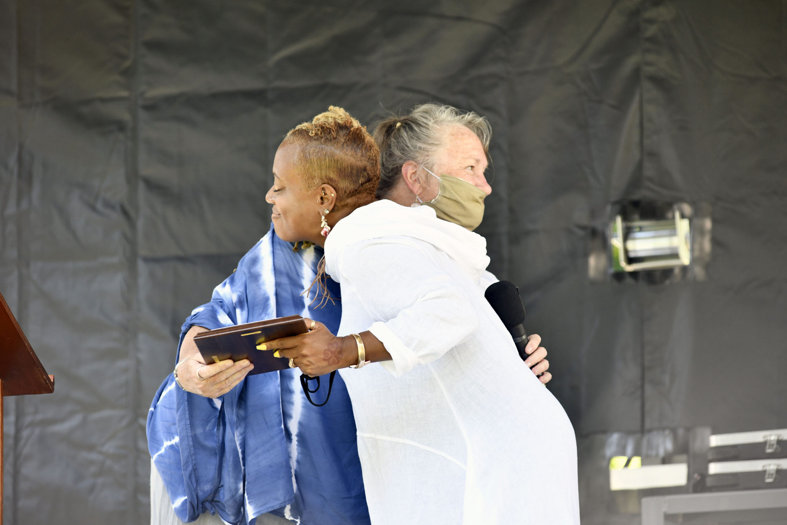 Parishioners and friends and well-wishers came to the grounds of the Southampton Arts Center to bid farewell to Reverend Leslie Duroseau of the Hamptons United Methodist Church in Southampton Village on Sunday. Carol Gilbert Lynch presents Rev. Duroseau with a plaque. DANA SHAW