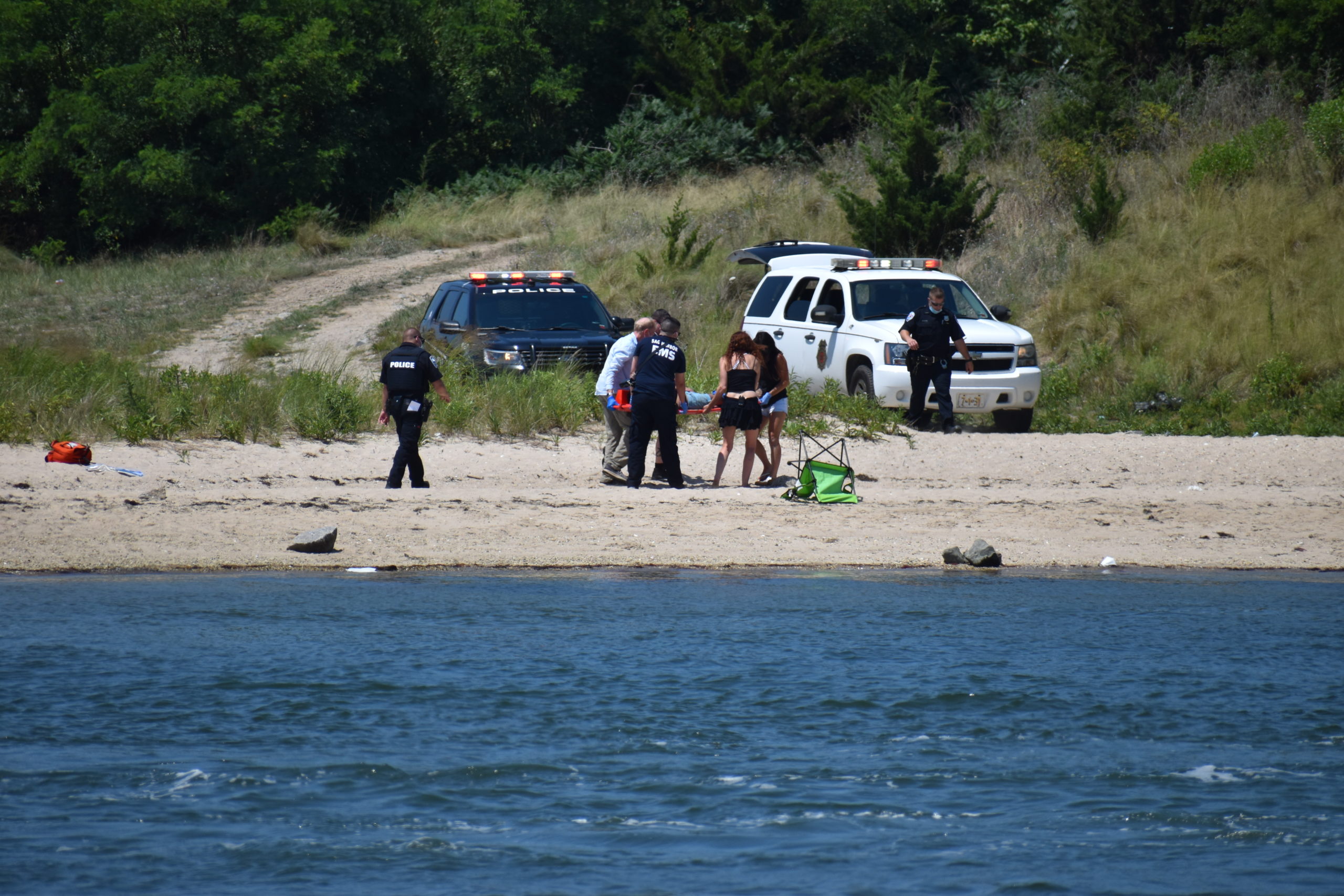 First responders pulled three swimmers from the water near North Haven Bridge Sunday. STEPHEN KOTZ
