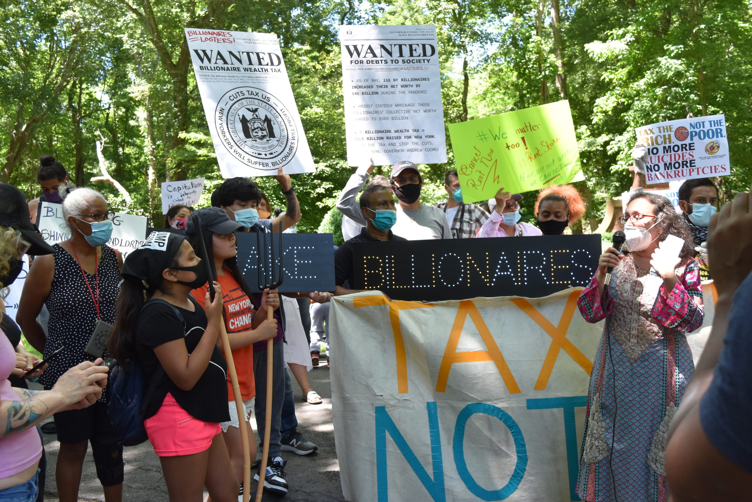 A protest caravan descened on the homes of East End billionaires, incluing the home of former New York City Mayor Michael Bloomberg, Wednesday with demonstrators demanding that Gov. Andrew Cuomo implement a wealth tax. 