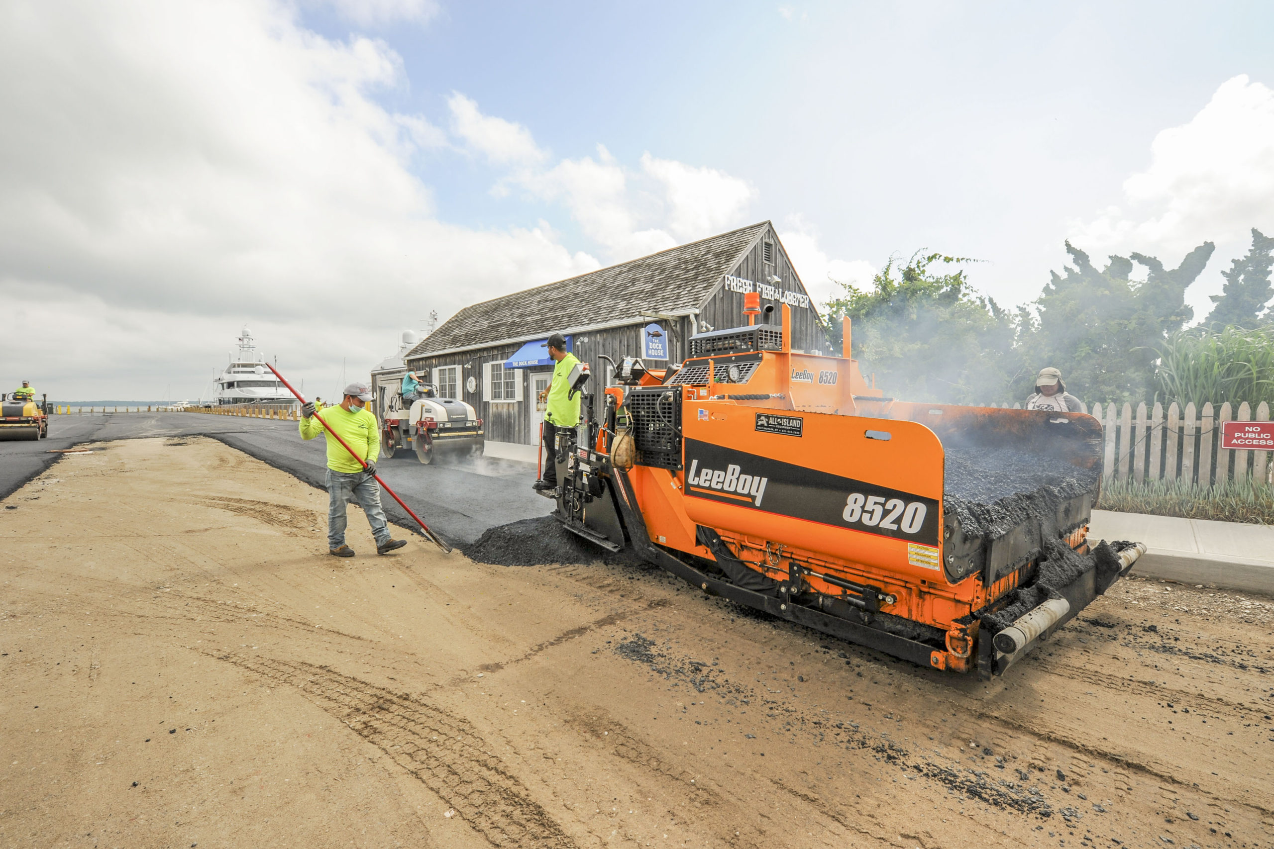 Workers were busy paving Long Wharf in Sag Harbor in anticipation of its reopening in time for the July 4 weekend. MICHAEL HELLER