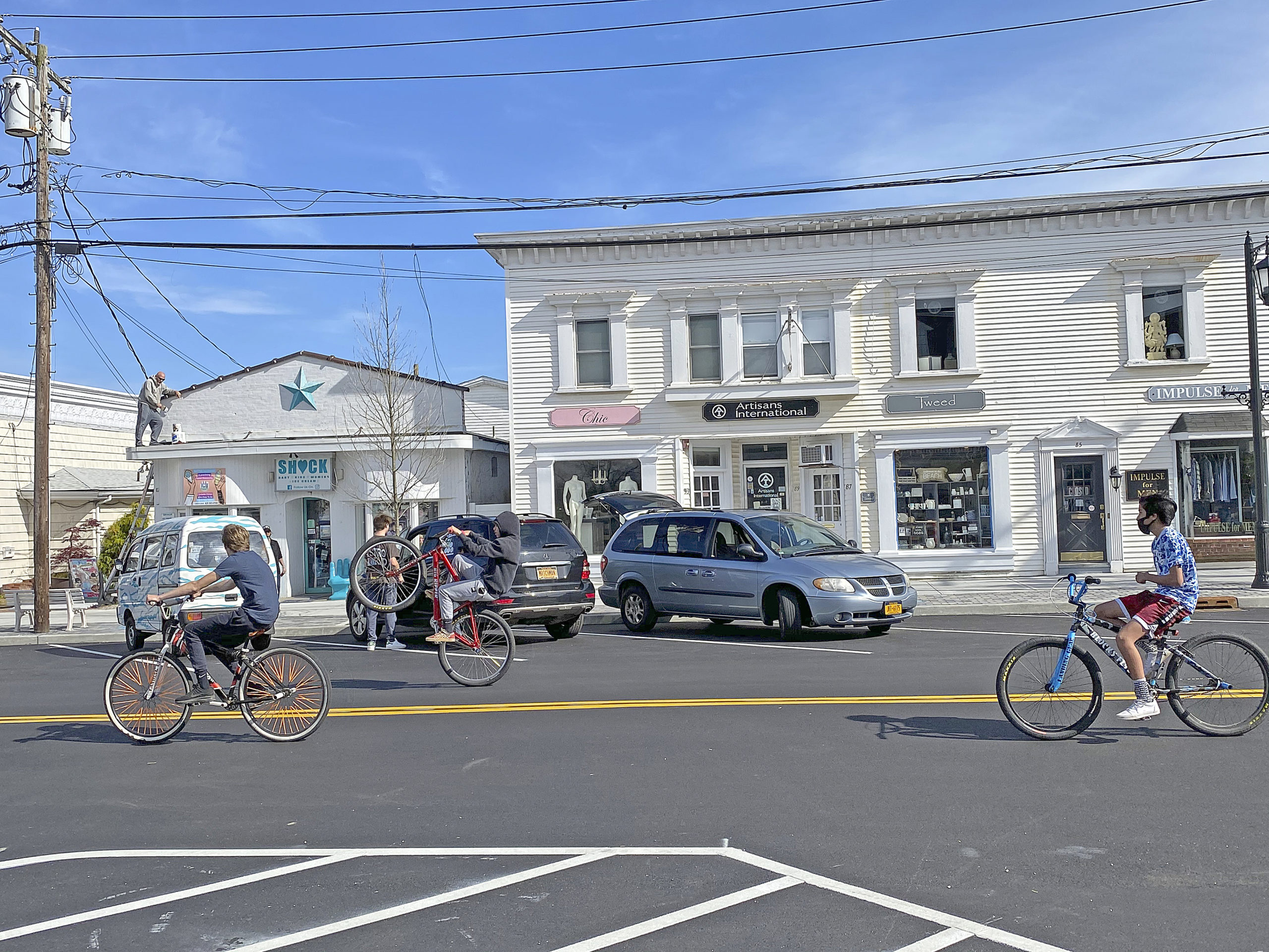 Kids pop wheelies on Main Street in Westhampton Beach.  DANA SHAW