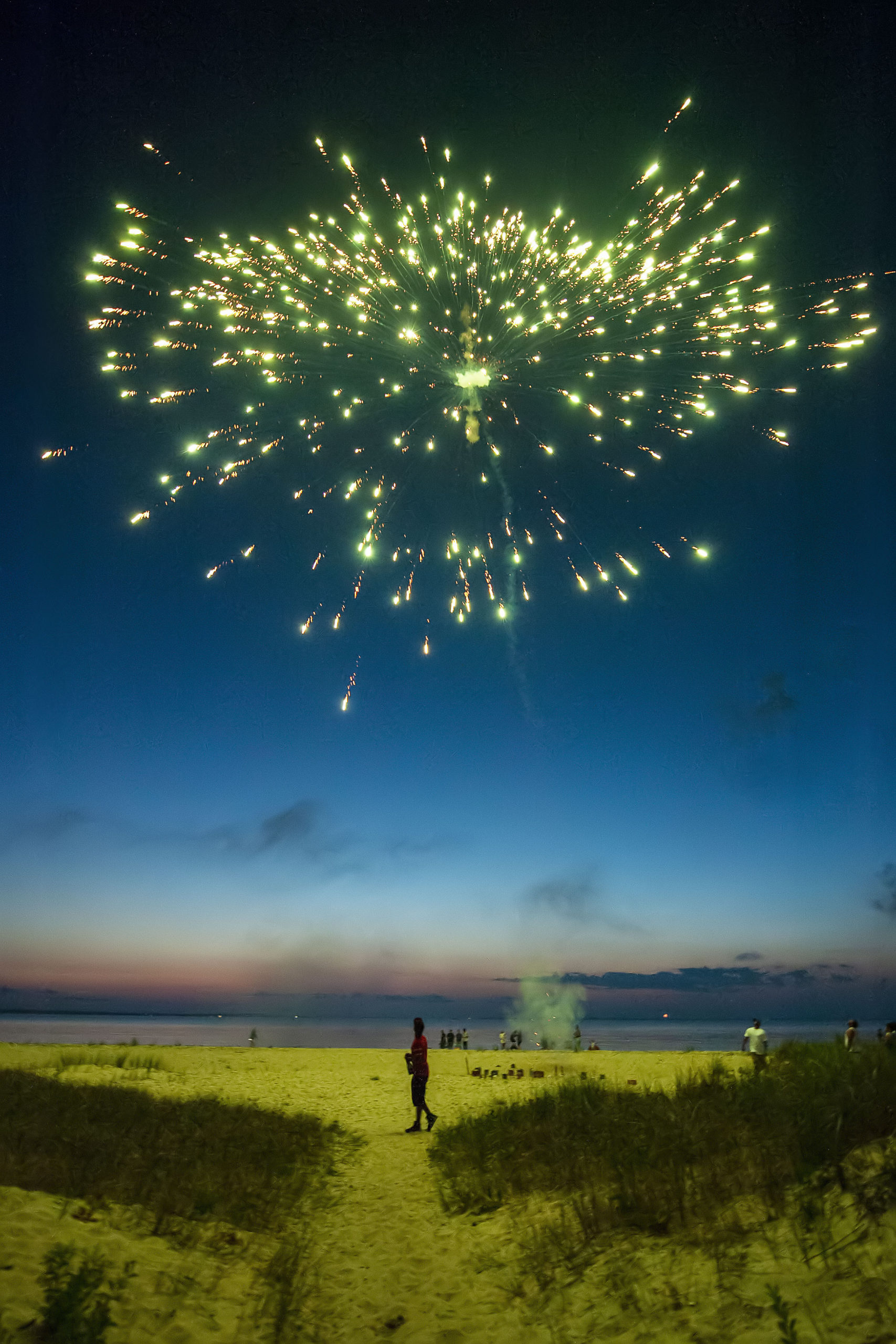A group of friends sets off their own fireworks on the beach as part of a July 4th celebration as the sun goes down at Maidstone Park Beach on Saturday evening. MICHAEL HELLER