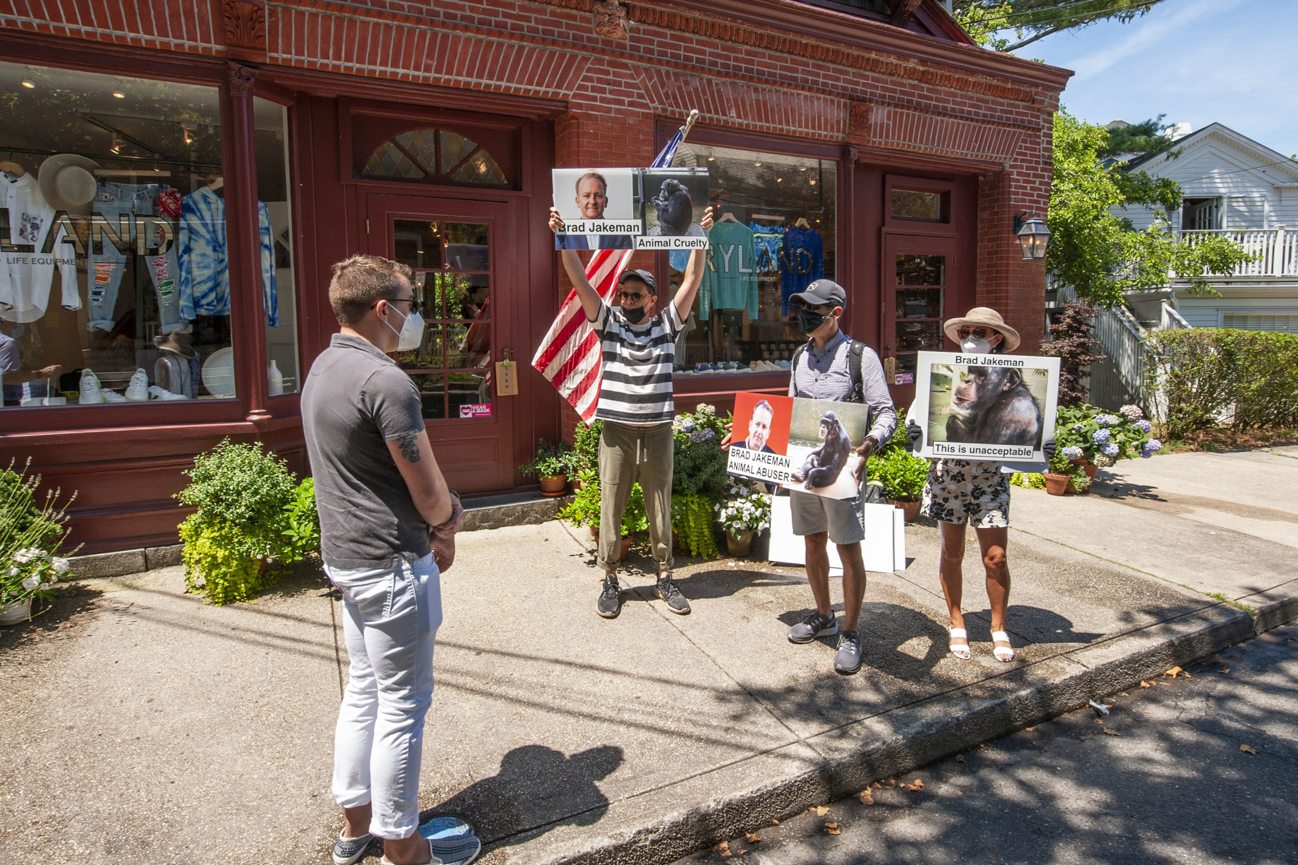 Protesters gathered on Madison Street in Sag Harbor on Saturday, July 25, demonstrating against mistreatment of chimpanzees at a Georgia sancturary. MICHAEL HELLER
